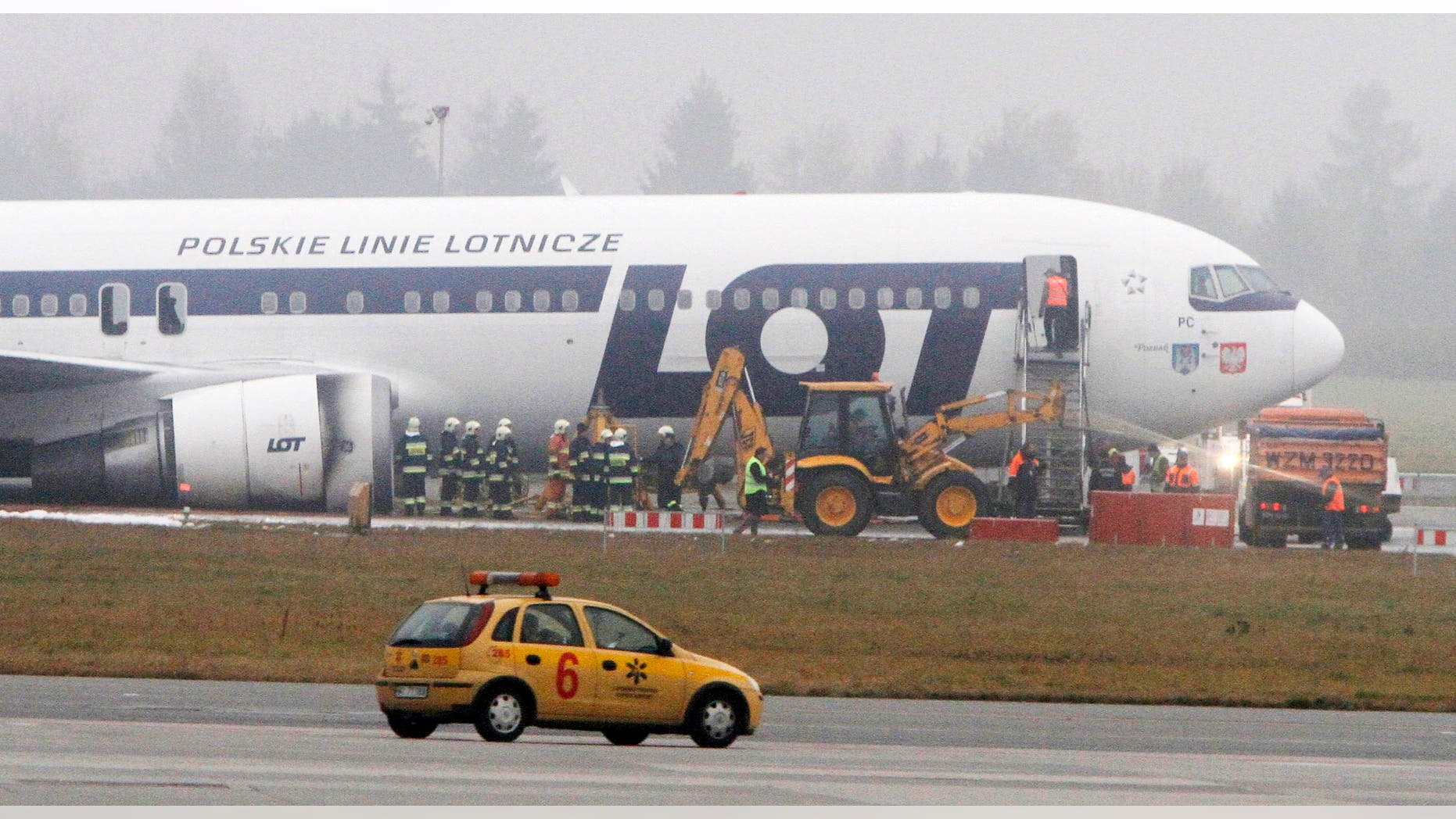 Nov. 2, 2011: Staff of the Frederic Chopin airport in Warsaw, Poland, prepare to move a Boeing 767 of Polish LOT airlines to unblock one of the airport's two runways and allow for air traffic.
