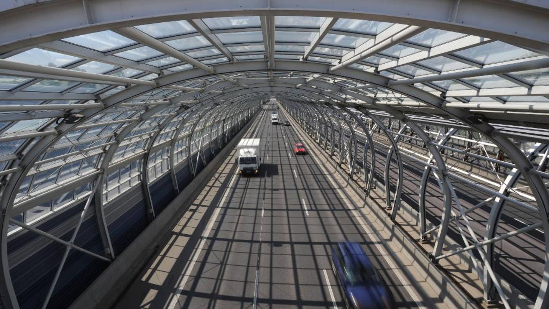 Cars drive through a soundproof tunnel covering a highway in Warsaw, Poland, Wednesday, April 30, 2014, one of the many investments built with the help of European Union funds. Poland joined the European Union a decade ago, a time that made monumental changes in the country as well as in some other former Soviet satellite states in east and central Europe. (AP Photo/Alik Keplicz)