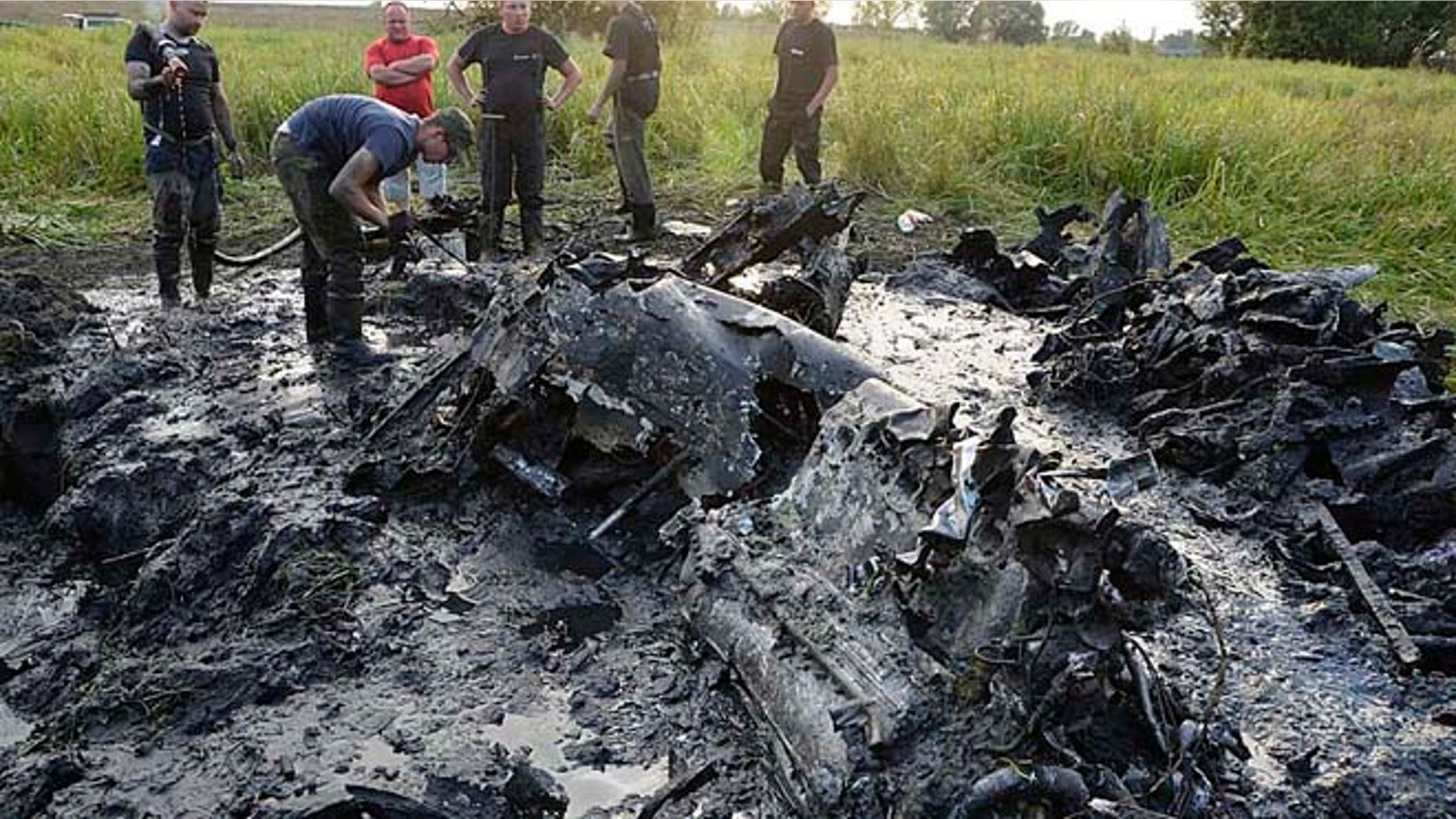 Aug. 23, 2015: Firefighters are retrieving the remains of a Soviet WW II fighter-bomber plane from muddy riverbed near Wyszogrod, Poland.