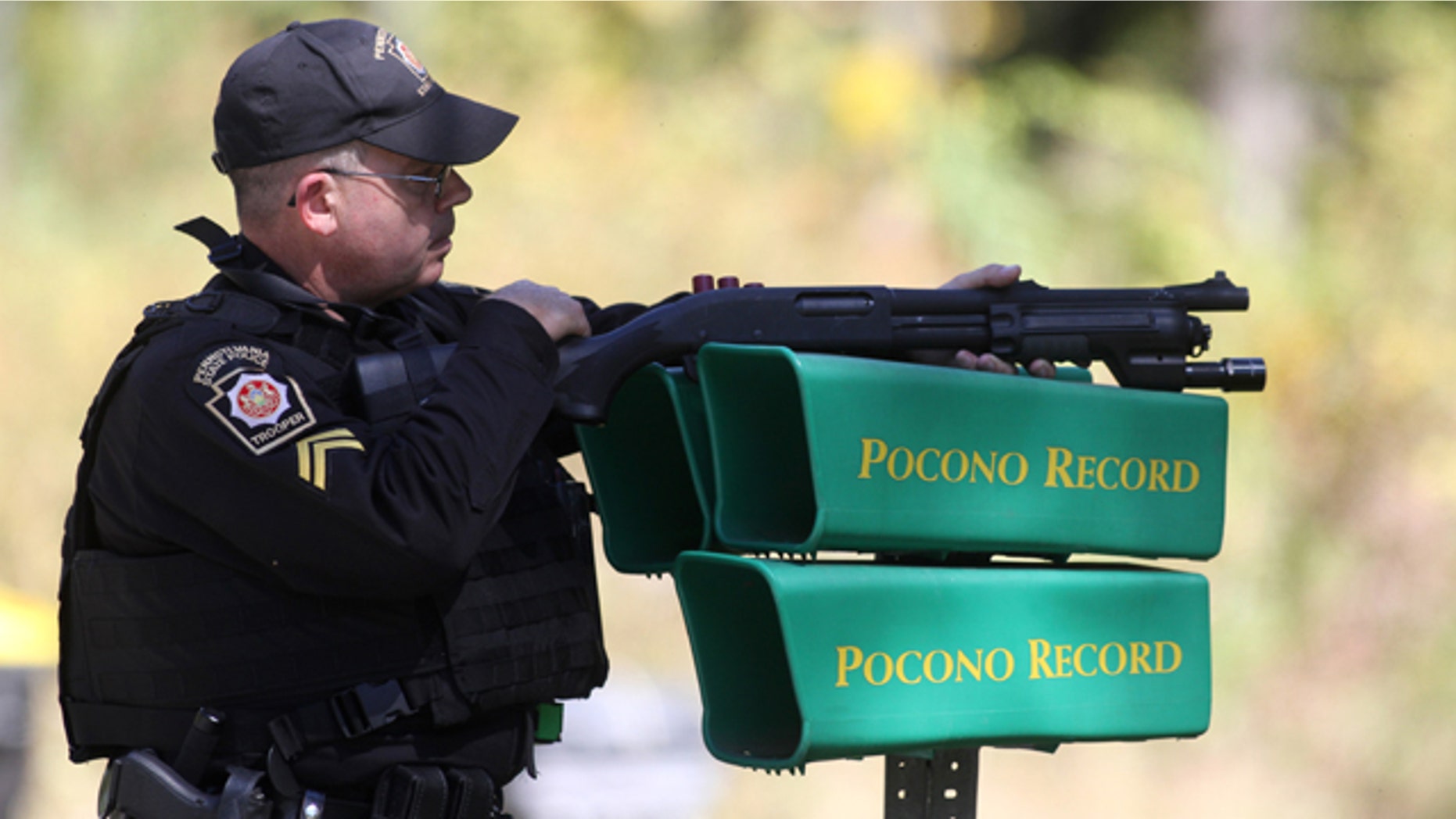September 23, 2014: A Pennsylvania State Police trooper helps create a perimeter in the search area for accused cop killer Eric Frien near the intersection of Happy Hill Lane and Bear Town Road in Canadensis, Pa. (AP Photo/The Times-Tribune, Jake Danna Stevens)