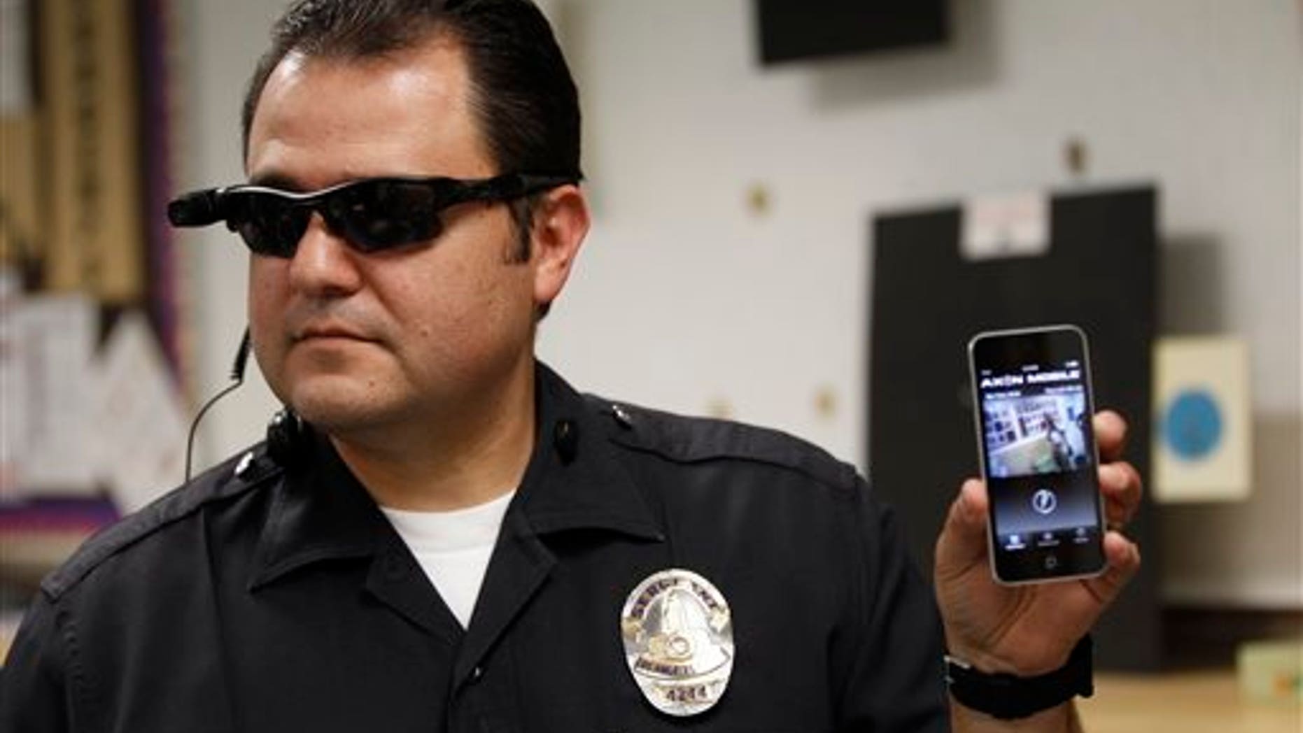 This Jan. 15, 2014 file photo shows Los Angeles Police Sgt. Daniel Gomez demonstrating a video feed from his camera into his cellphone as on-body cameras are demonstrated for the media in Los Angeles. Thousands of police agencies have equipped officers with cameras to wear with their uniforms, but theyve frequently lagged in setting policies on how theyre used, potentially putting privacy at risk and increasing their liability. As officers in one of every six departments across the nation now patrols with tiny lenses on their chests, lapels or sunglasses, administrators and civil liberties experts are trying to envision and address troublesome scenarios that could unfold in front of a live camera. (AP Photo/Damian Dovarganes)