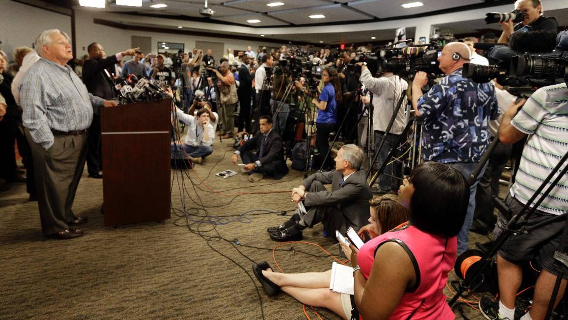 Mayor Keith Summey, left, speaks about the shooting death of Walter Scott during a news conference at city hall in North Charleston, S.C., Wednesday, April 8, 2015. Scott was killed by a North Charleston police officer after a traffic stop on Saturday. The officer, Michael Thomas Slager, has been charged with murder. (AP Photo/Chuck Burton)