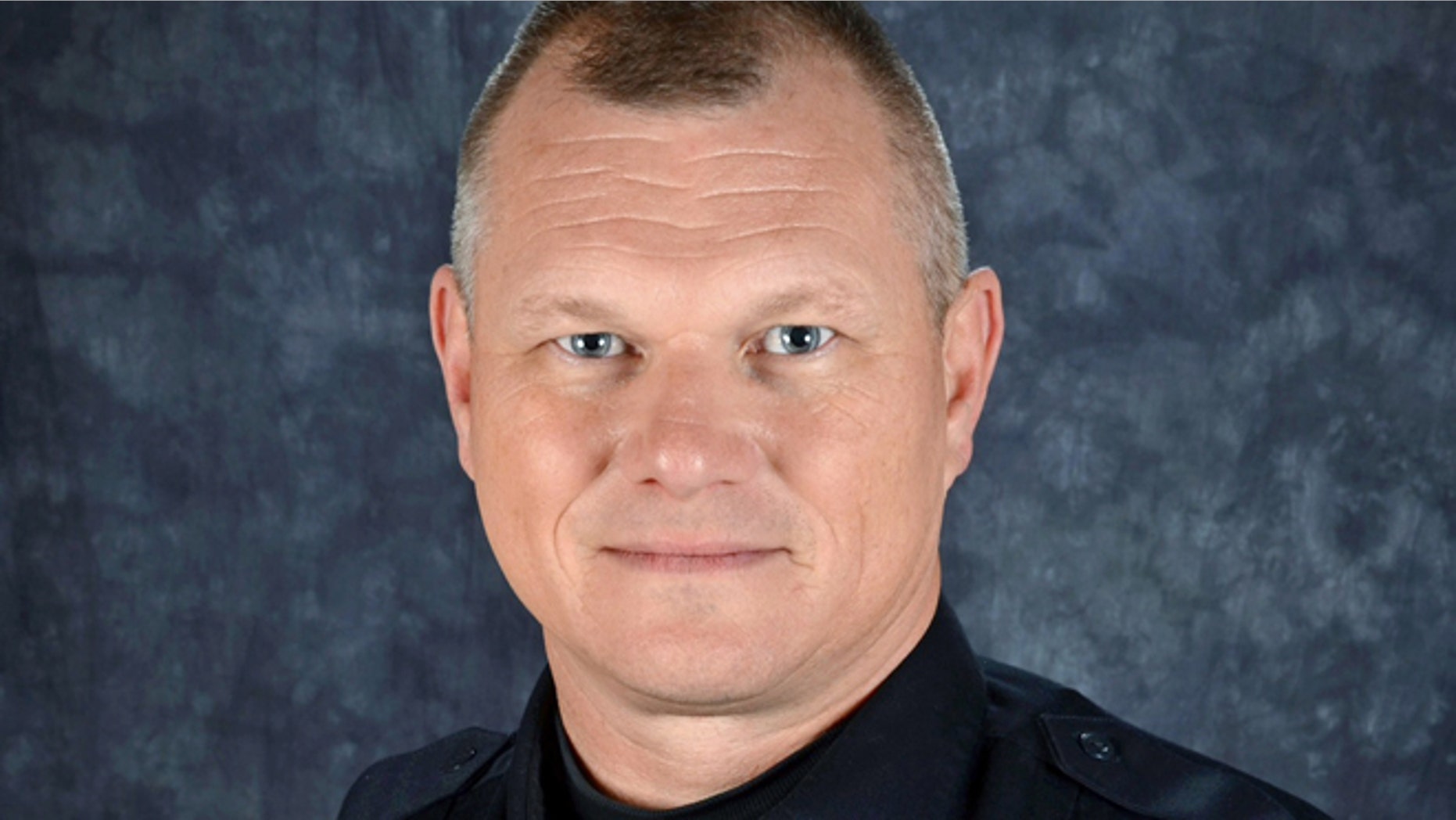 An ex-convict was charged in the shooting of officer Dan Webster.