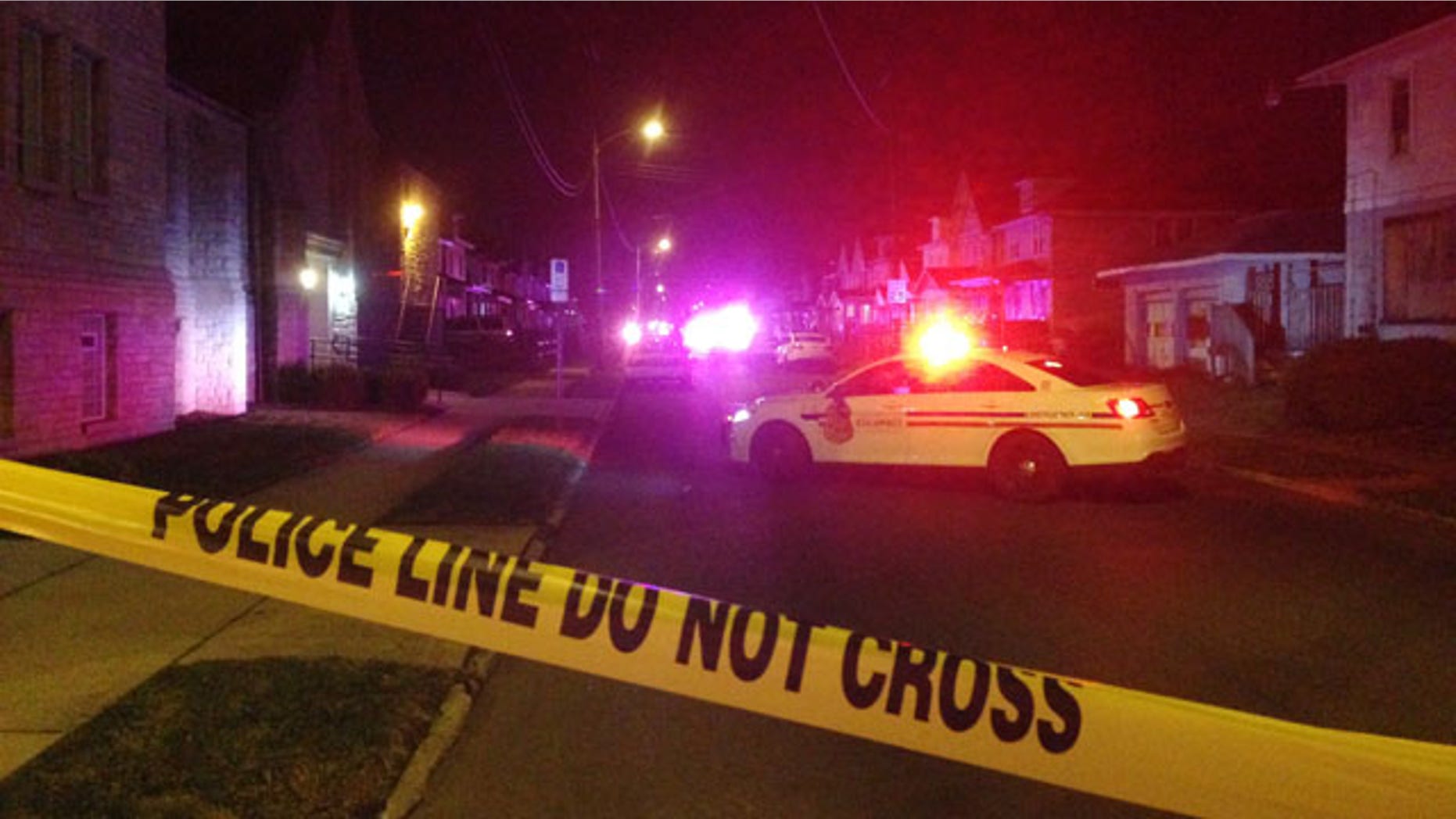 Nov. 23, 2015: Police block off an area after a fatal shooting in Columbus, Ohio. Police said a married couple and their 7-year-old son were shot and wounded while the couple's 12-year-old daughter was wounded (AP Photo/Andrew Welsh-Huggins)