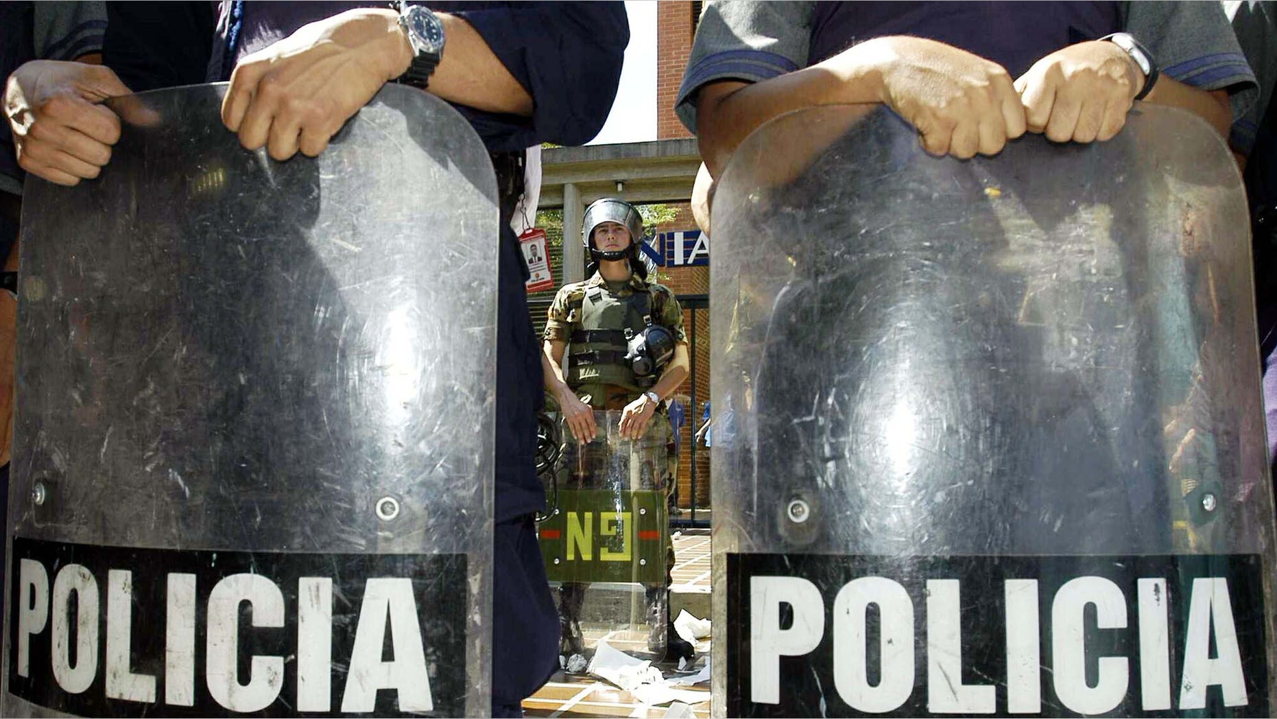 CARACAS, VENEZUELA - JANUARY 7: National Guard soldiers guard tax offices (SENIAT) during a protest by the opposition of Venezuelan President Hugo Chavez January 7, 2003 in Caracus, Venezuela. Thousands of protesters marched on the tax office urging people to withold tax payments from the Venezuelan government. Chavez warned that not paying taxes is a crime and punishable with seven years in prison.