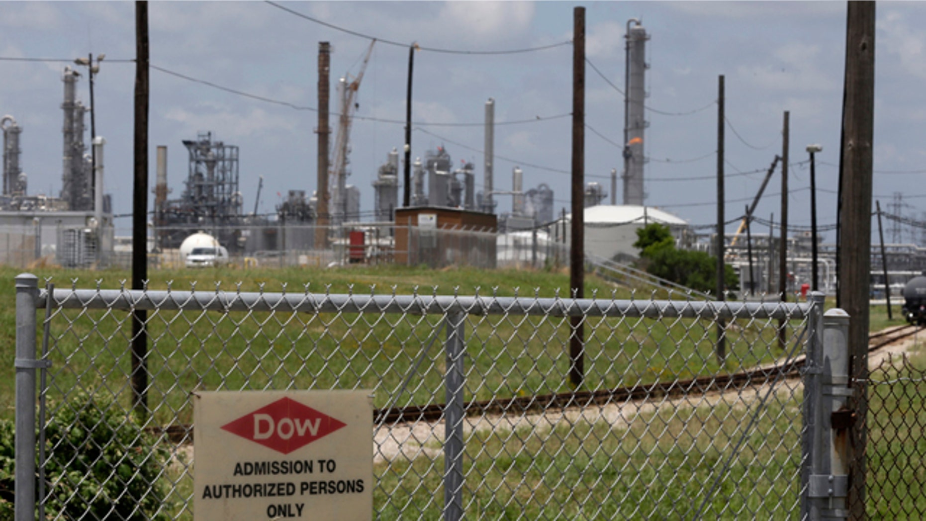 May 22, 2014: A sign is posted on a roadside fence outside a Dow Chemicals plant in Freeport, Texas. (AP Photo/Pat Sullivan)