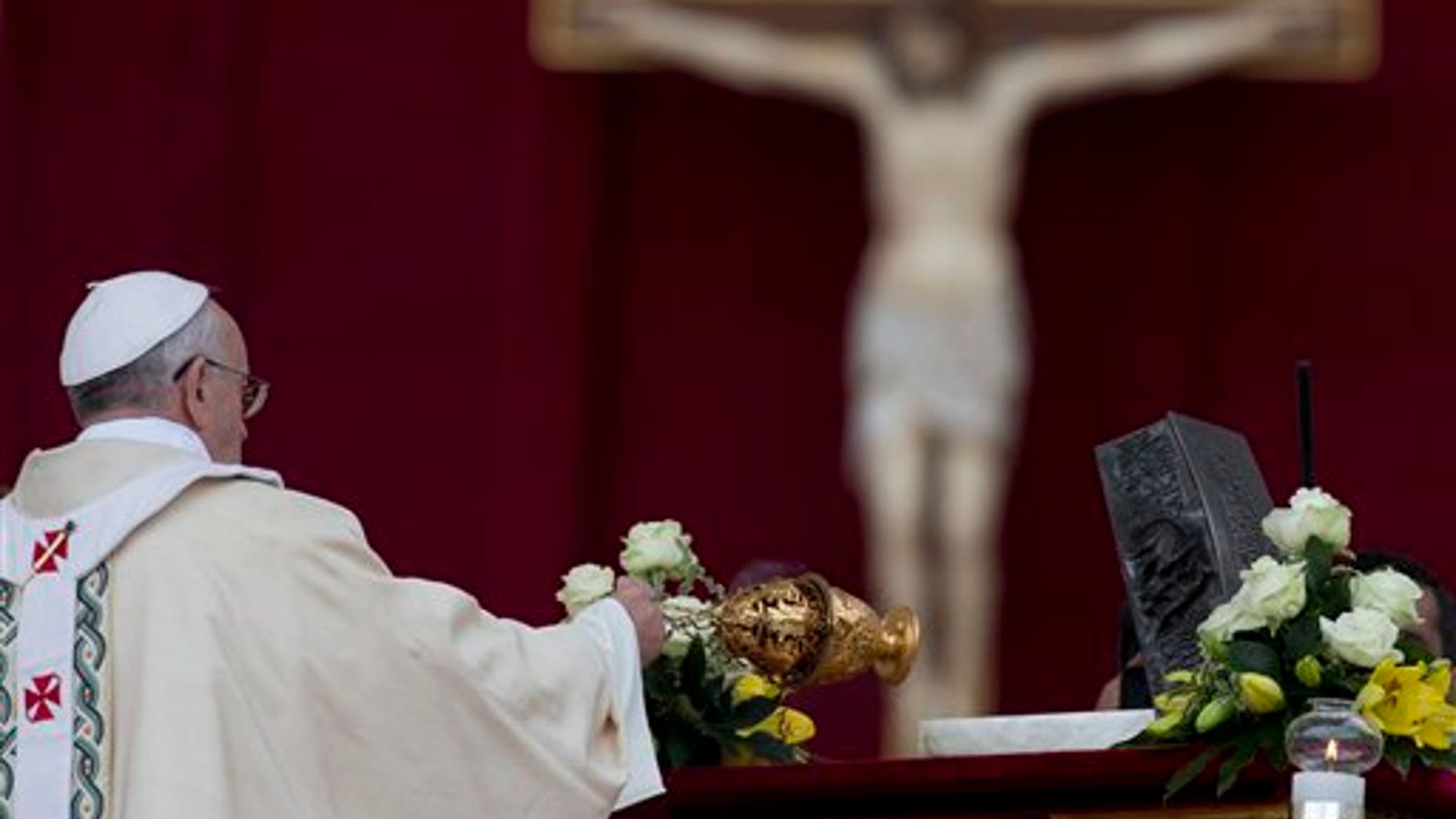 Pope Francis blesses the relics of St. Peter as he celebrates mass for the end of the Year of Faith, in St. Peter's Square at the Vatican, Sunday, Nov. 24, 2013. (AP Photo/Andrew Medichini)