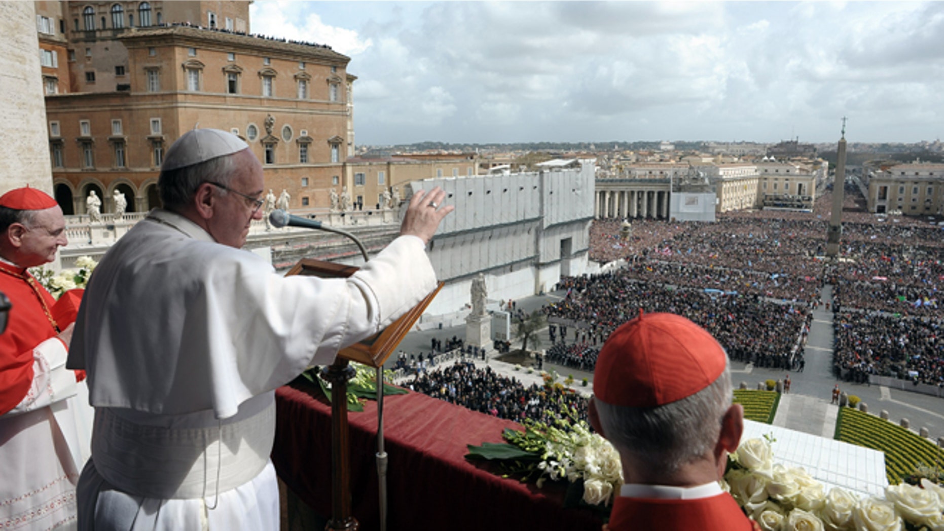 In this photo provided by the Vatican newspaper L'Osservatore Romano, Pope Francis delivers the Urbi et Orbi (to the city and to the world) blessing, in St. Peter's Square at the Vatican, Sunday, March 31, 2013. Pope Francis celebrated his first Easter Sunday Mass as pontiff in St. Peter's Square, packed by joyous pilgrims, tourists and Romans and bedecked by spring flowers.Wearing cream-colored vestments, Francis strode onto the esplanade in front of St. Peter's Basilica and took his place at an altar set up under a white canopy. (AP Photo/L'Osservatore Romano)
