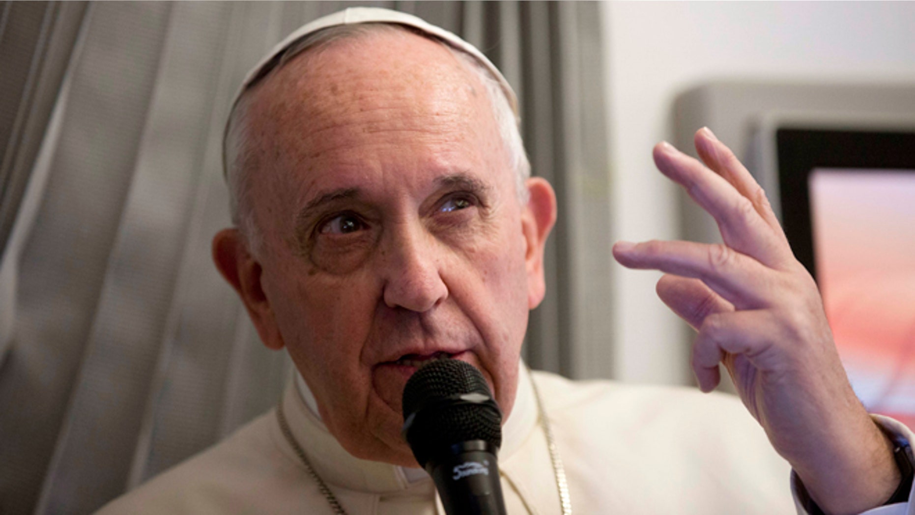 Pope Francis talks with reporters during his flight from Sri Lanka to Manila, Philippines Thursday, Jan. 15, 2015. (AP Photo/Alessandra Tarantino, Pool)