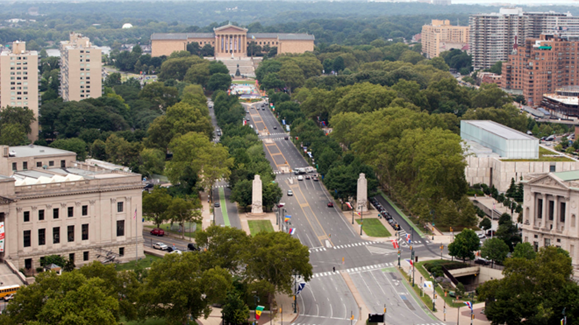 Viewed from the Embassy Suites hotel traffic moves along the Benjamin Franklin Parkway leading to the Philadelphia Museum of Art, Thursday, July 30, 2015, in Philadelphia. On the parkway Pope Francis is scheduled to visit The World Meeting of Families' festival and celebrate a Mass during his visit to the United States. (AP Photo/Matt Rourke)
