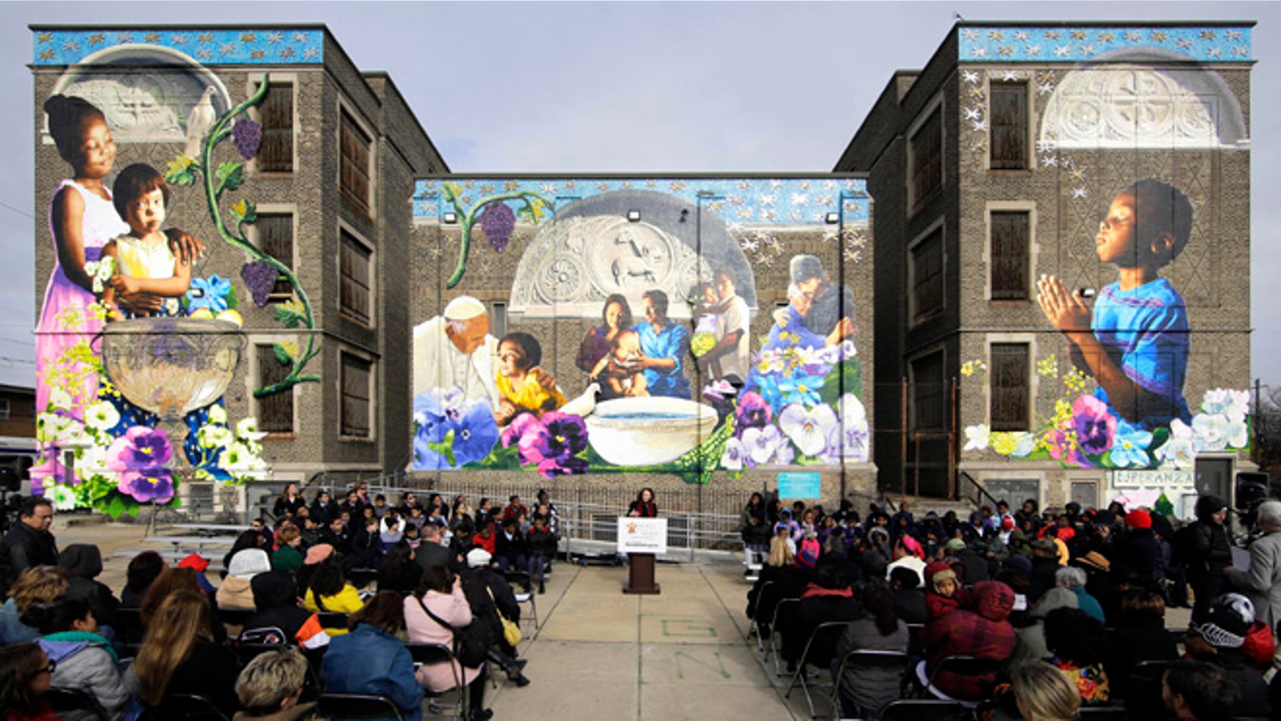 Jane Golden, executive director of the City of Philadelphia Mural Arts Program, speaks during a ceremony dedicating the mural, titled The Sacred Now: Faith and Family in the 21st Century, Monday, Nov. 30, 2015, in Philadelphia. Organizers are hoping the mural featuring Pope Francis is eligible for the Guinness World Record for âMost Contributions to a Painting by Numbers.â More than 2,700 people, including the pontiff himself, helped create the multistory artwork. (AP Photo/Matt Rourke)