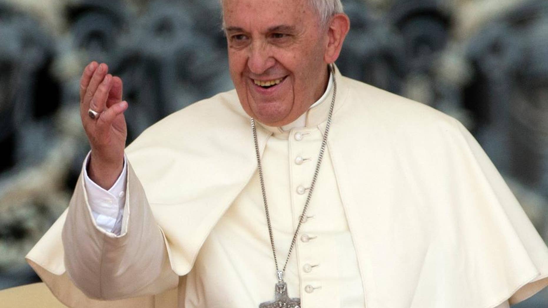 FILE - In this Wednesday, May 20, 2015, file photo, Pope Francis waves to faithful during his weekly general audience, in St. Peter's Square, at the Vatican. Pope Francis is joining a colorful cast of characters painted on the outside of buildings across Philadelphia. Officials announced Thursday, May 28, 2015, that hundreds of residents and visitors will help create a mural honoring the pontiff and families. Pope Francis is scheduled to visit Philadelphia in September. (AP Photo/Andrew Medichini, File)