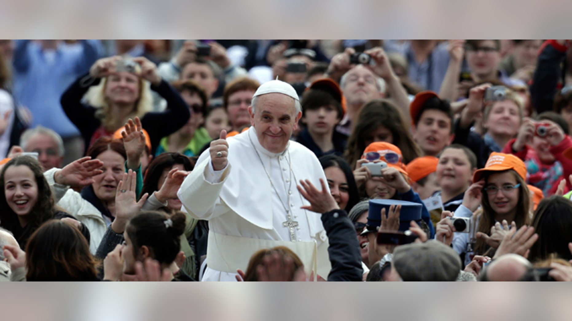 Pope Francis waves to faithful as he is driven through the crowd with his popemobile in St. Peter's Square prior to the start of his weekly general audience at the Vatican, Wednesday, April 10, 2013. (AP Photo/Alessandra Tarantino)