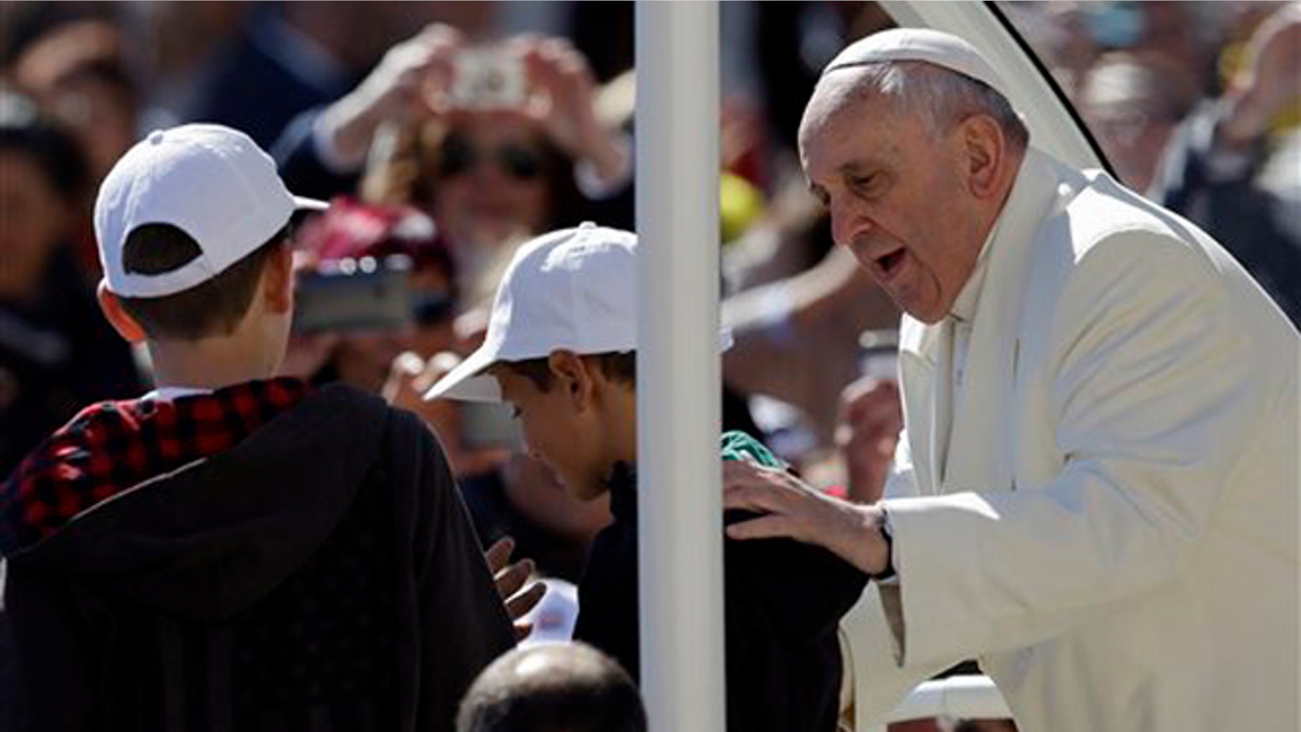Pope Francis greets 11-year-olds Livio Bastianelli and Davide Maria Bianchi Wednesday, April 16, 2014.