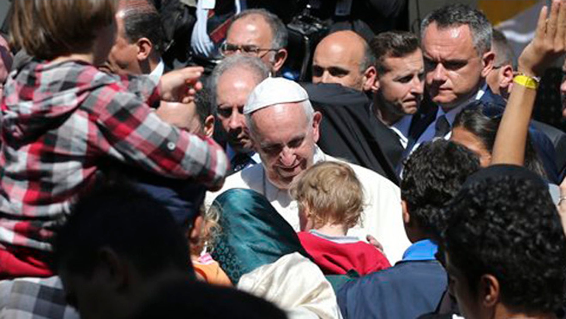 Pope Francis meets migrants at the Moria refugee camp on the Greek island of Lesbos, Saturday April 16, 2016. Pope Francis travelled Saturday to Greece for a brief but provocative visit to meet with refugees at a detention center as the European Union implements a controversial plan to deport them back to Turkey. (AP Photo/Petros Giannakouris)