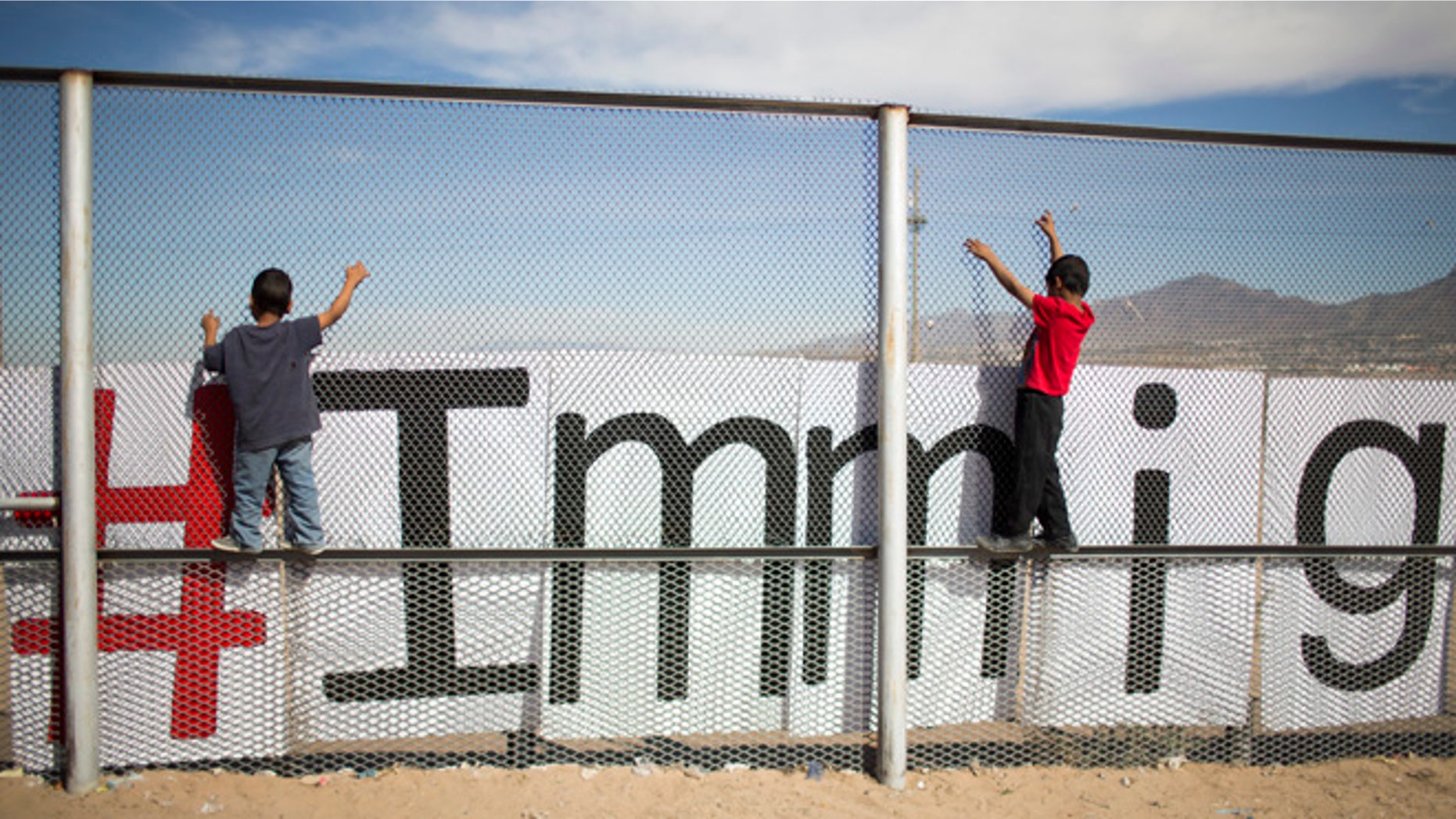 Two small boys balance themselves on the rail of a border fence during an event organized by the Border Network for Human Rights, on the outskirts of Ciudad Juarez, Mexico, Monday, Feb. 15, 2016. Pope Francis will conclude his weeklong Mexico trip with a visit to Ciudad Juarez where he will meet with Mexican workers, grassroots groups and employers in an encounter where heâll likely repeat his mantra on the need for dignified work for all and âland, labor and lodging.â (AP Photo/Ivan Pierre Aguirre)