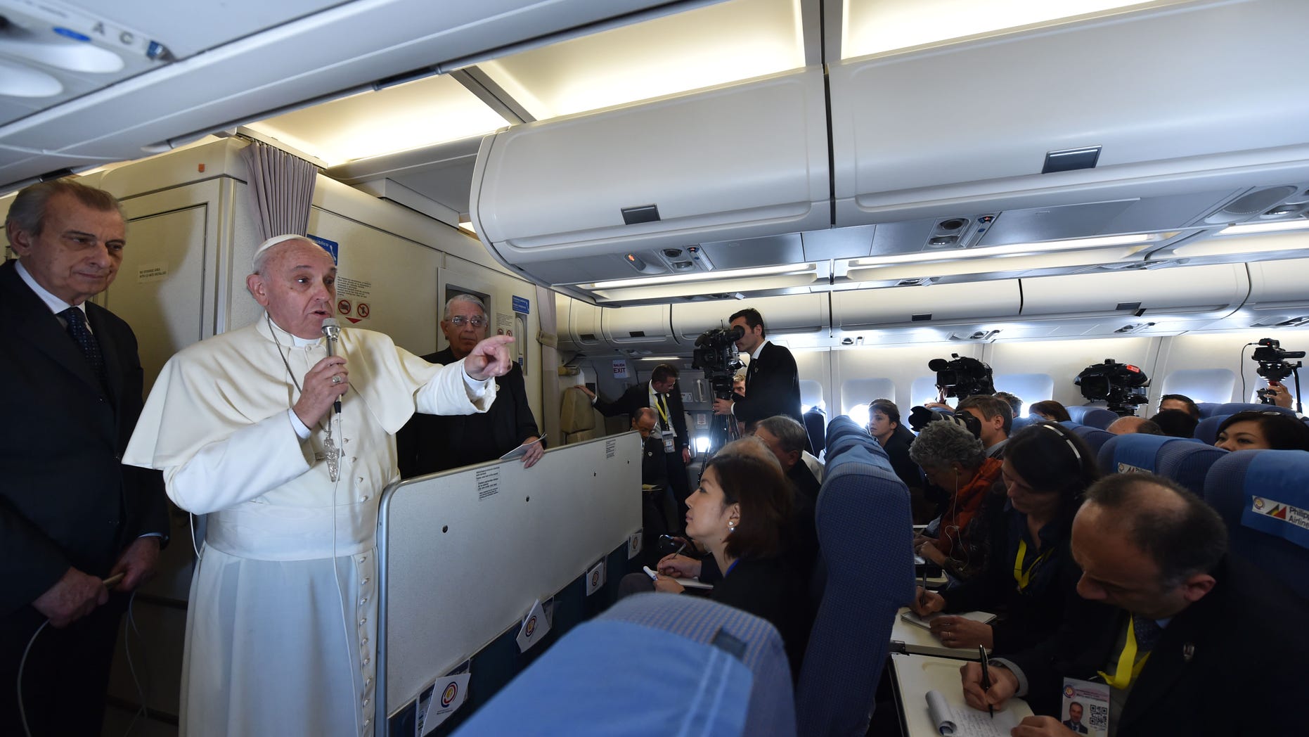 Jan. 19, 2015 - Pope Francis talks with journalists during his flight from Manila to Rome. Although the trips are unconfirmed, Francis is expected to visit Philadelphia, the White House, and the UN in New York in September.
