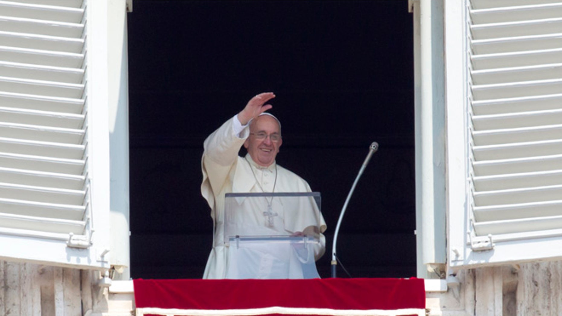 Aug. 9, 2015: Pope Francis waves before reciting the Angelus noon prayer from his window overlooking St. Peter's Square at the Vatican, in Italy.