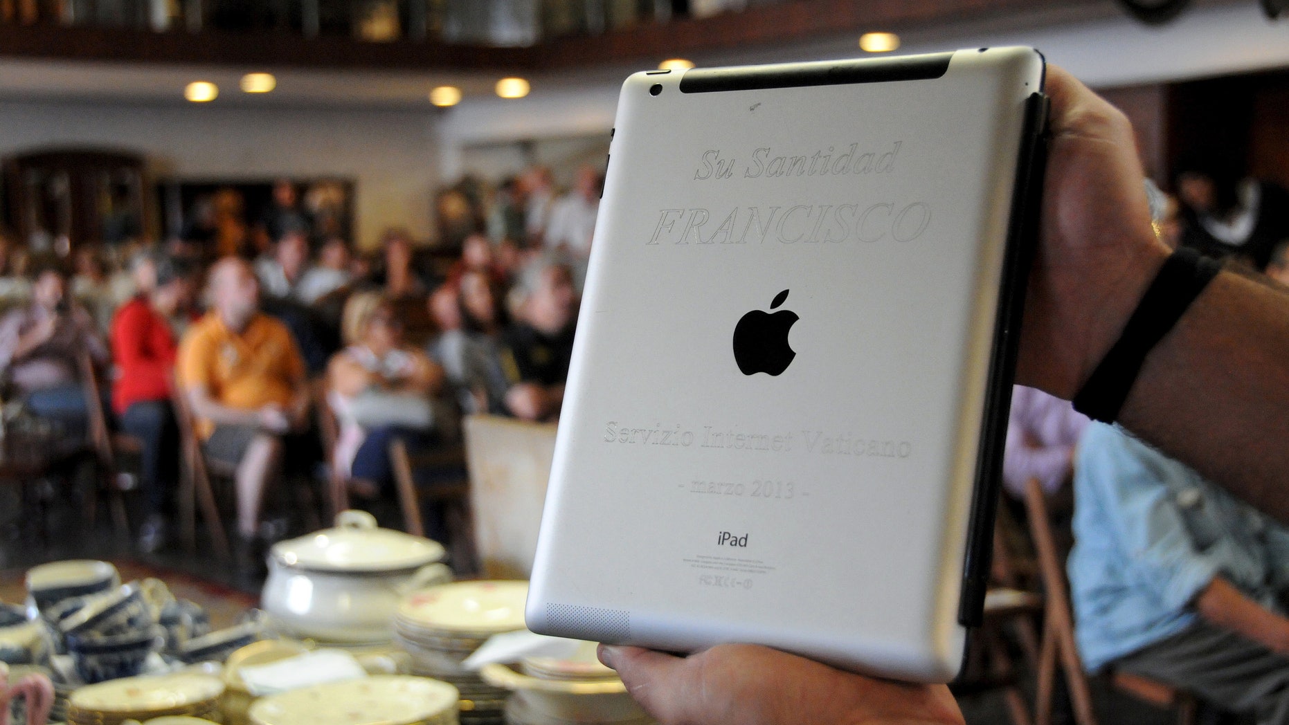 An Apple iPad which belonged to Pope Francis is seen at Castells auction house in Montevideo, April 14, 2015.