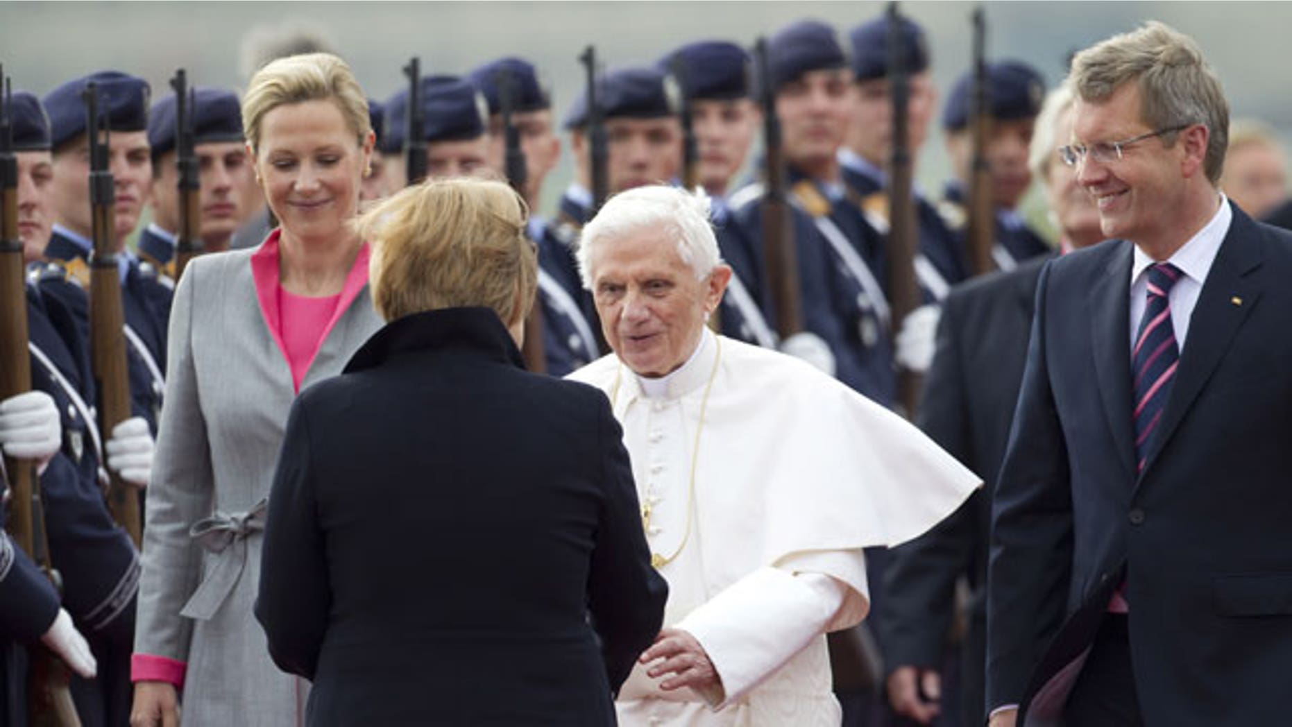 September 22: German Chancellor Angela Merkel, front, welcomes Pope Benedict XVI, center, after his arrival at the Tegel airport in Berlin, Germany.