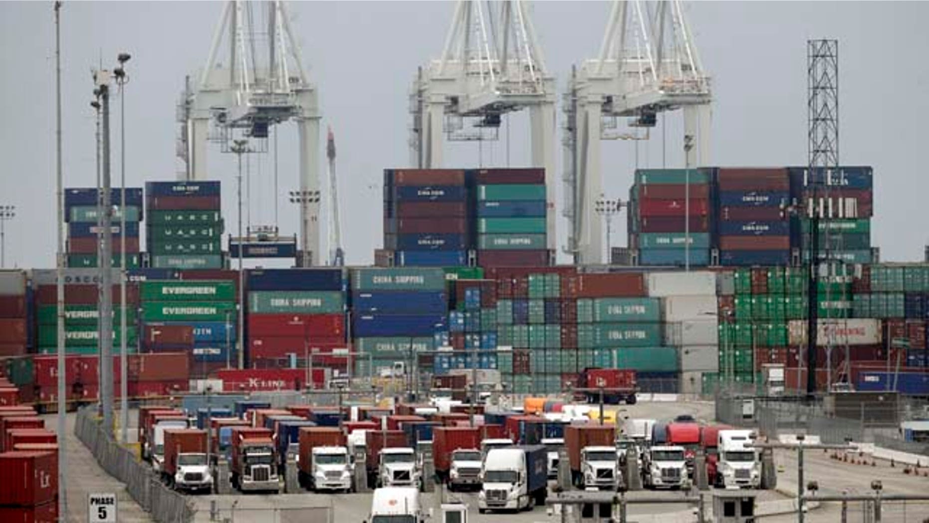 FILE - In this Tuesday, Feb. 17, 2015, file photo, cargo trucks wait in line at the Port of Long Beach, in Long Beach, Calif. Maritime companies that are locked in a contract dispute with West Coast dockworkers took their case directly to rank-and-file longshoremen Wednesday, Feb. 18, as negotiators for both sides struggled to reach a deal and break cargo gridlock which has stalled billions of dollars of international trade. (AP Photo/Jae C. Hong, File)