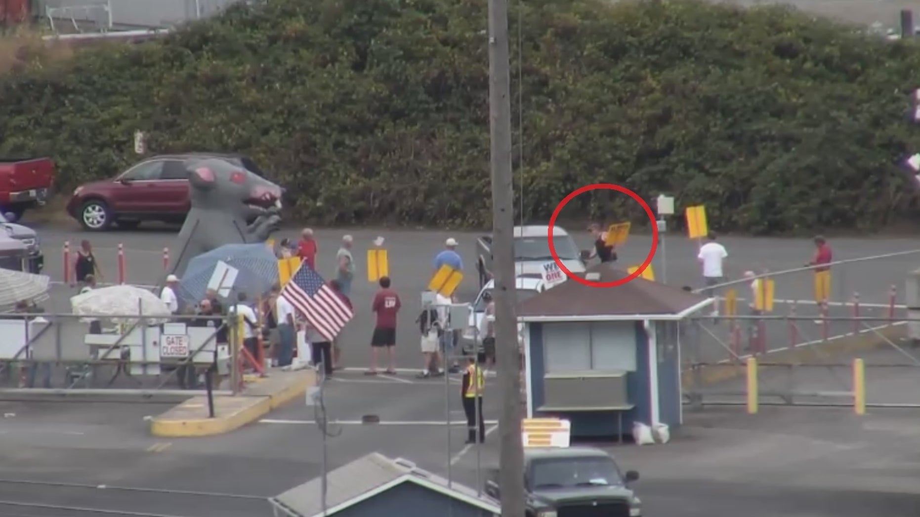 In this Port of Vancouver surveillance video footage from 2013, a member from ILWU Local 4 is seen trying to open the door of a state grain inspectors vehicle after confronting the official for trying to enter the facility.