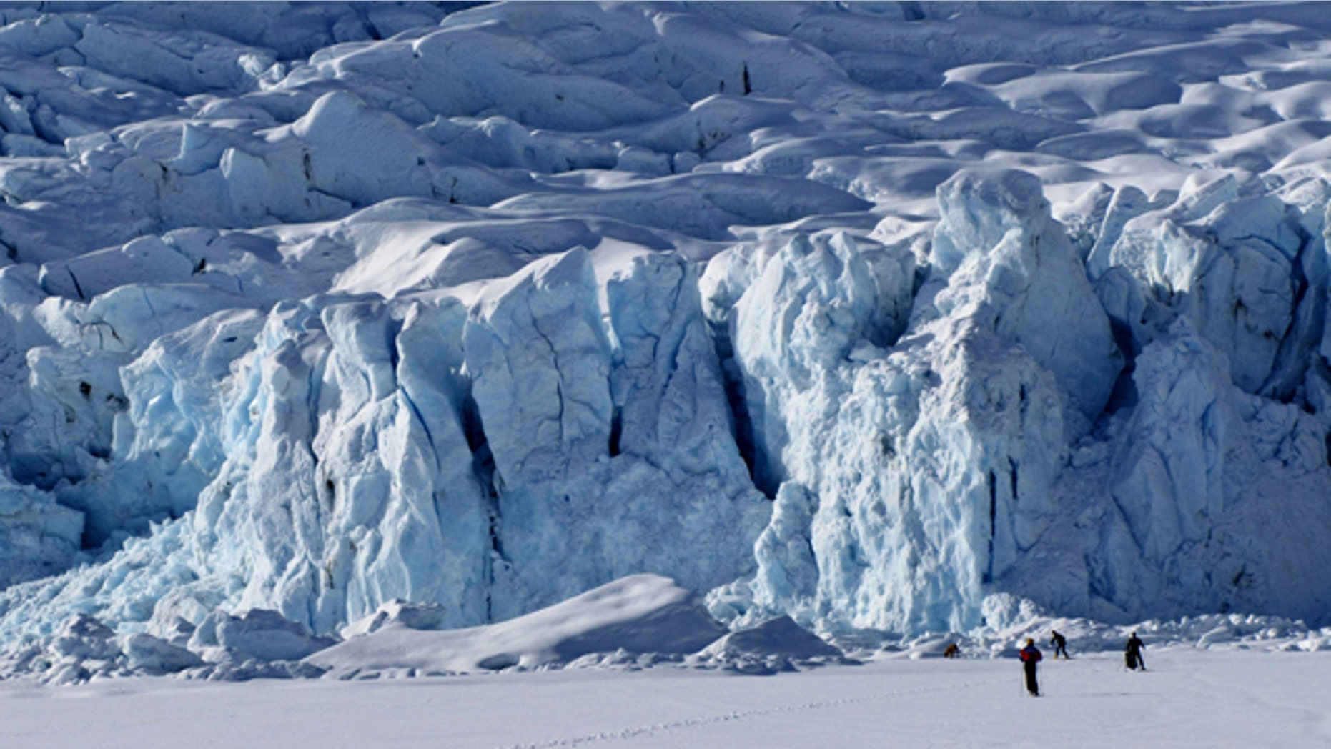 Cross-country skiers approach Portage Glacier as they ski across frozen Portage Lake, Alaska on Saturday, April 3, 2010.