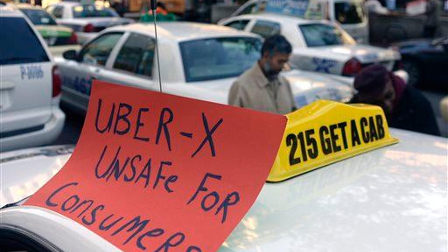 Drivers with the Taxi Workers Alliance of Pennsylvania protest Uber.