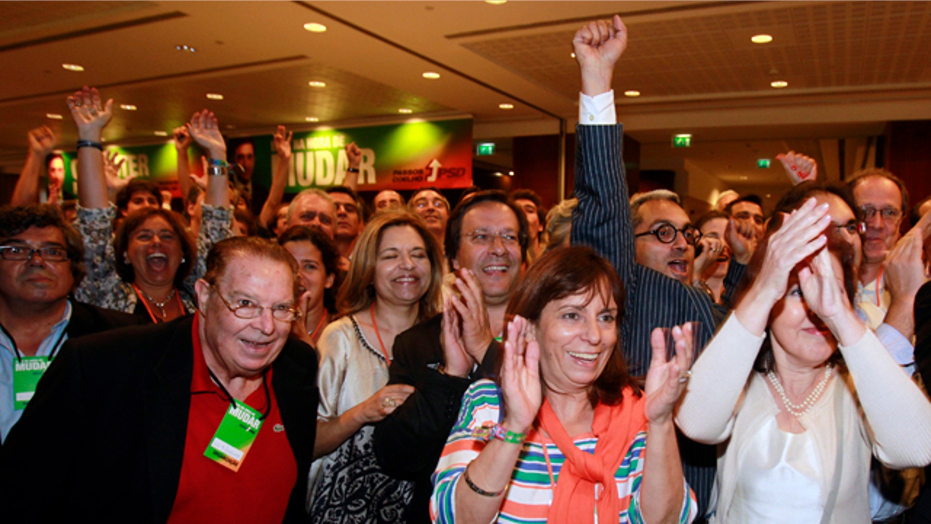 June 5: Supporters of the center-right Social Democratic Party, PSD, react to the exit polls results shown on TV screens seconds after voting closed in Portugal at a hotel in Lisbon. Exit polls showed the PSD unseating the ruling Socialist Party.