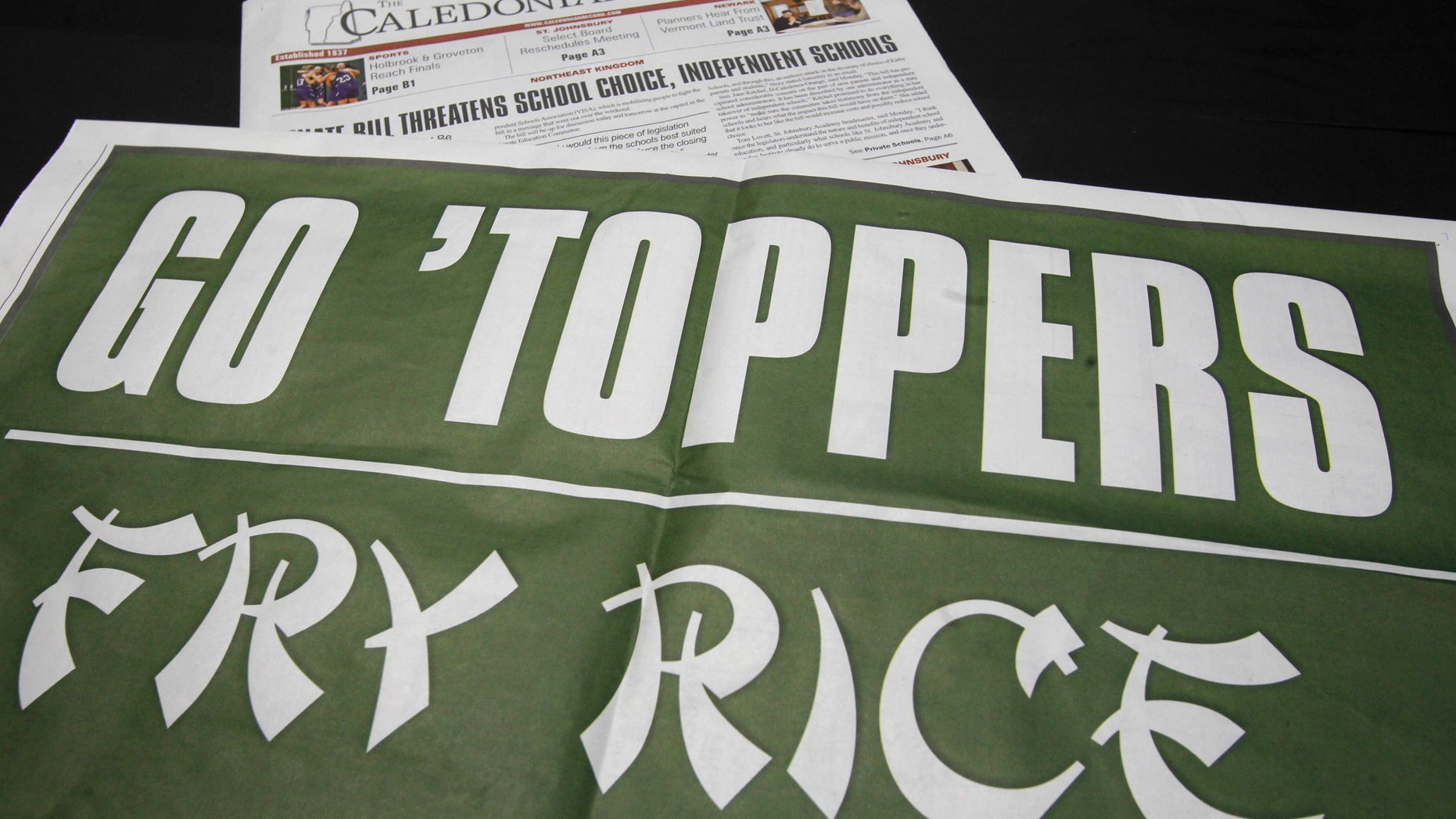 A copy of the Caledonian Record lies on display, Friday, March 8, 2013 in Montpelier, Vt. The Vermont newspaper is being criticized for a poster designed to boost the local high school basketball team before it played in the state championship.