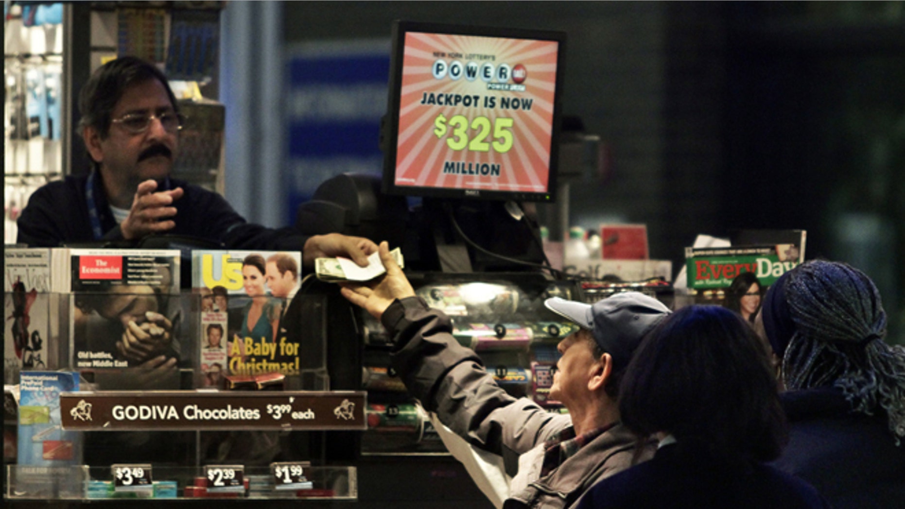 Nov. 23: A vendor, left, receives money for a lottery purchase in New York.