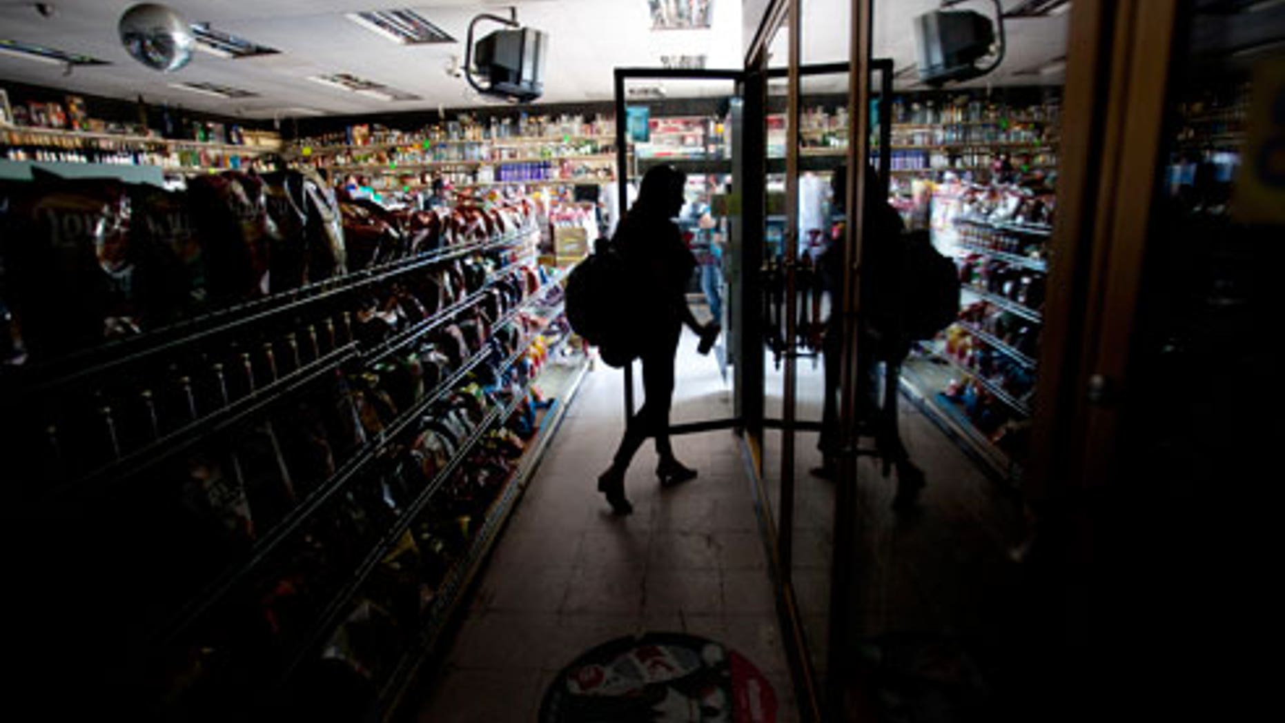 This Sept. 8, 2011 file photo shows Deborah Springs shopping in a convenience store for food items after a power outage in San Diego. There were no catastrophes caused by the widespread outage that knocked out power in a region with a population of nearly 6 million spanning both sides of the U.S.-Mexico border. But for individuals and institutions alike it was a defining moment that separated the Boy Scouts of the world from the rest of us.