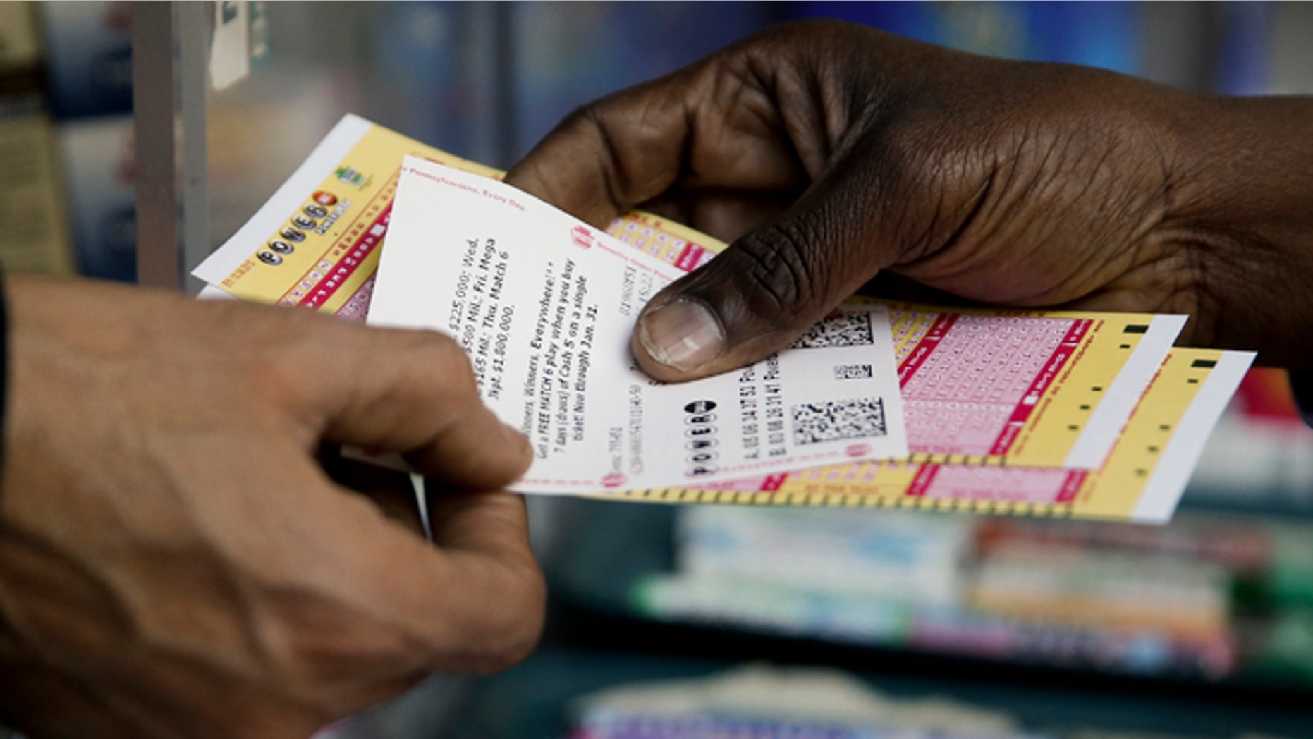 A person purchase Powerball lottery tickets from a newsstand Wednesday, Jan. 6, 2016, in Philadelphia. Players will have a chance Wednesday night at the biggest lottery prize in nearly a year. (AP Photo/Matt Rourke)