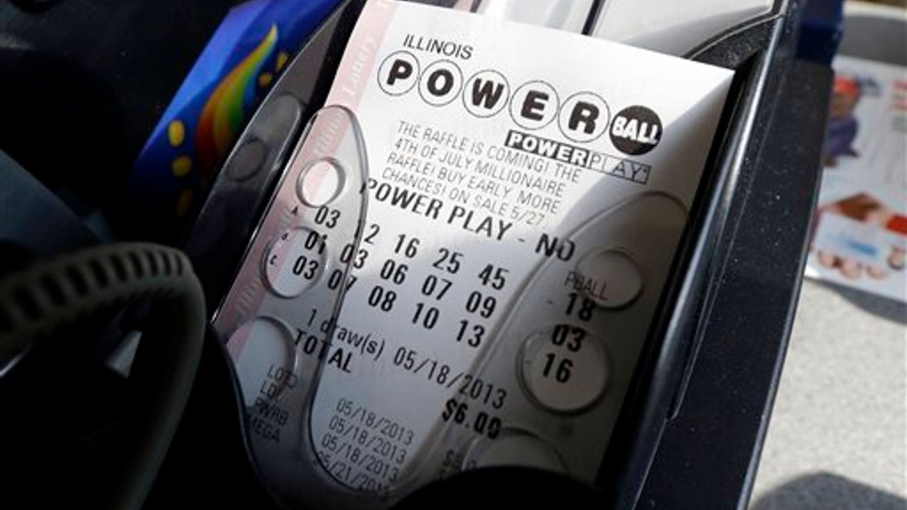 FILE - A Powerball lottery ticket is printed out of a lottery machine at a convenience store in Chicago on in this May 18, 2013 file photo. According to lottery officials there were no jackpot winner for Saturday Feb. 15, 2014 drawing. The current estimated jackpot for Wednesday's drawing's jackpot is estimated at $400 million or $227.8 million in cash value. (AP Photo/Nam Y. Huh, FILE)