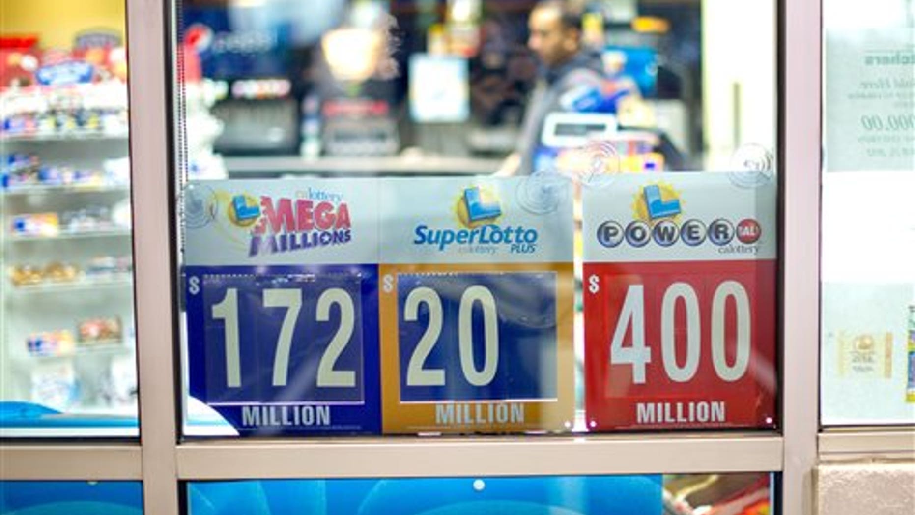 A night worker passes lottery signs at Dixon Landing Chevron in Milpitas, Calif., on Thursday, Feb. 20, 2014. According to California lottery officials, the store sold the lone winning ticket for a $425 million Powerball jackpot but there was no immediate word on who may have won one of the largest lottery jackpots in U.S. history. (AP Photo/Noah Berger)