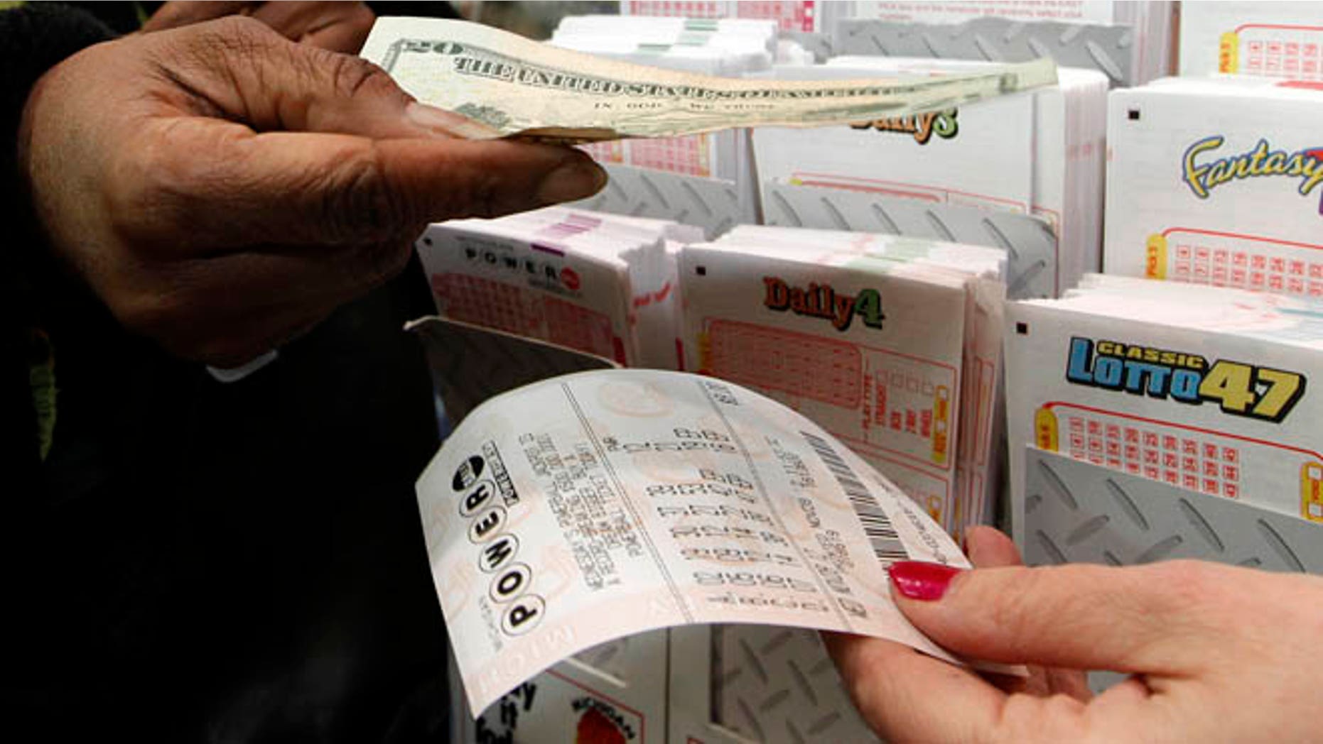 Nov. 28, 2012: Donna Fields pays for her Powerball tickets in Detroit.