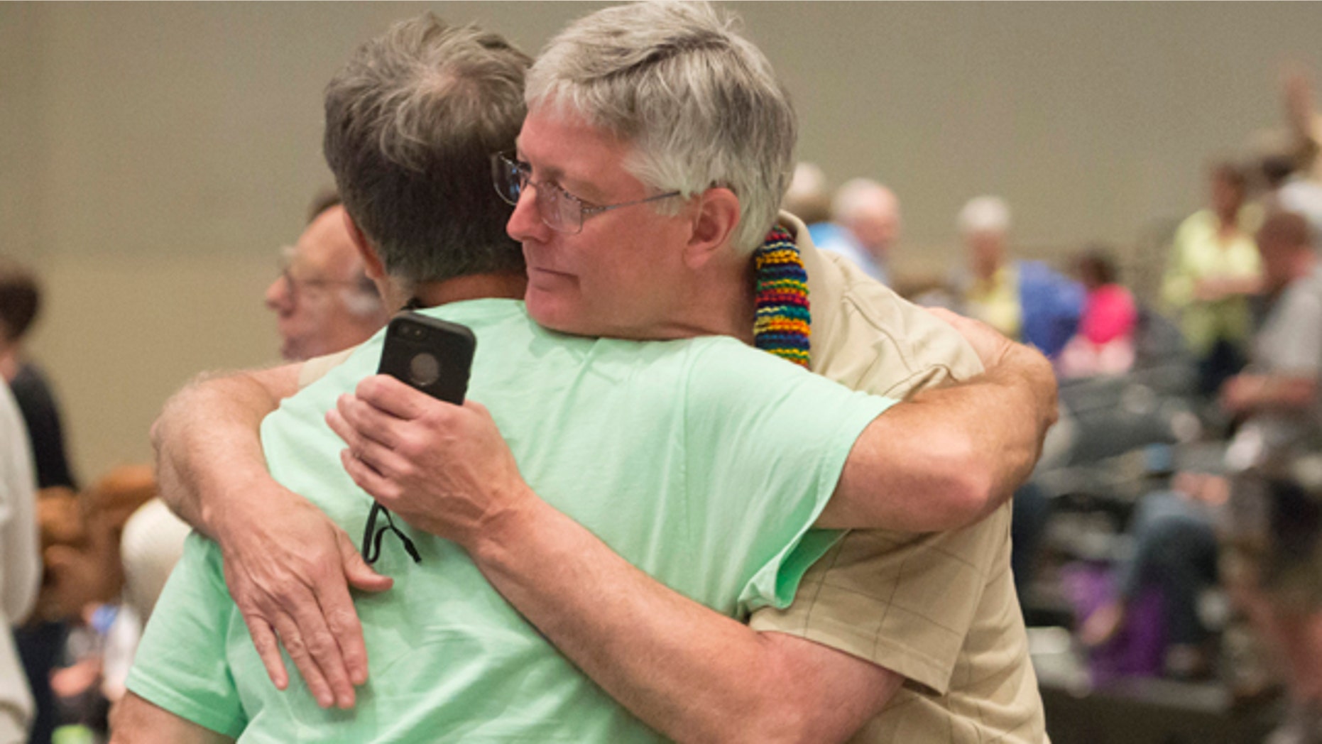 FILE - In this June 19, 2014, file photo, Gary Lyon, left, of Leechburg, Pa., and Bill Samford, of Hawley, Pa., celebrate after a vote allowing Presbyterian pastors discretion in marrying same-sex couples at the 221st General Assembly of the Presbyterian Church at Cobo Hall, in Detroit. (AP Photo/Detroit News, David Guralnick, File)