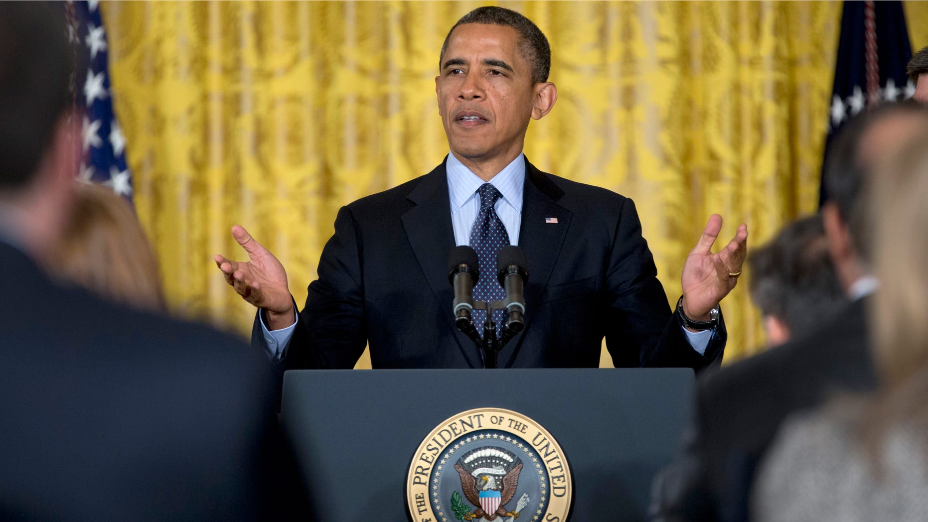 President Barack Obama gestures to the audience as he arrives in the East Room of the White House in Washington, Friday, Jan. 25, 2013, to announce that he will name current Deputy National Security Adviser Denis McDonough as his next chief of staff. (AP Photo/Carolyn Kaster)