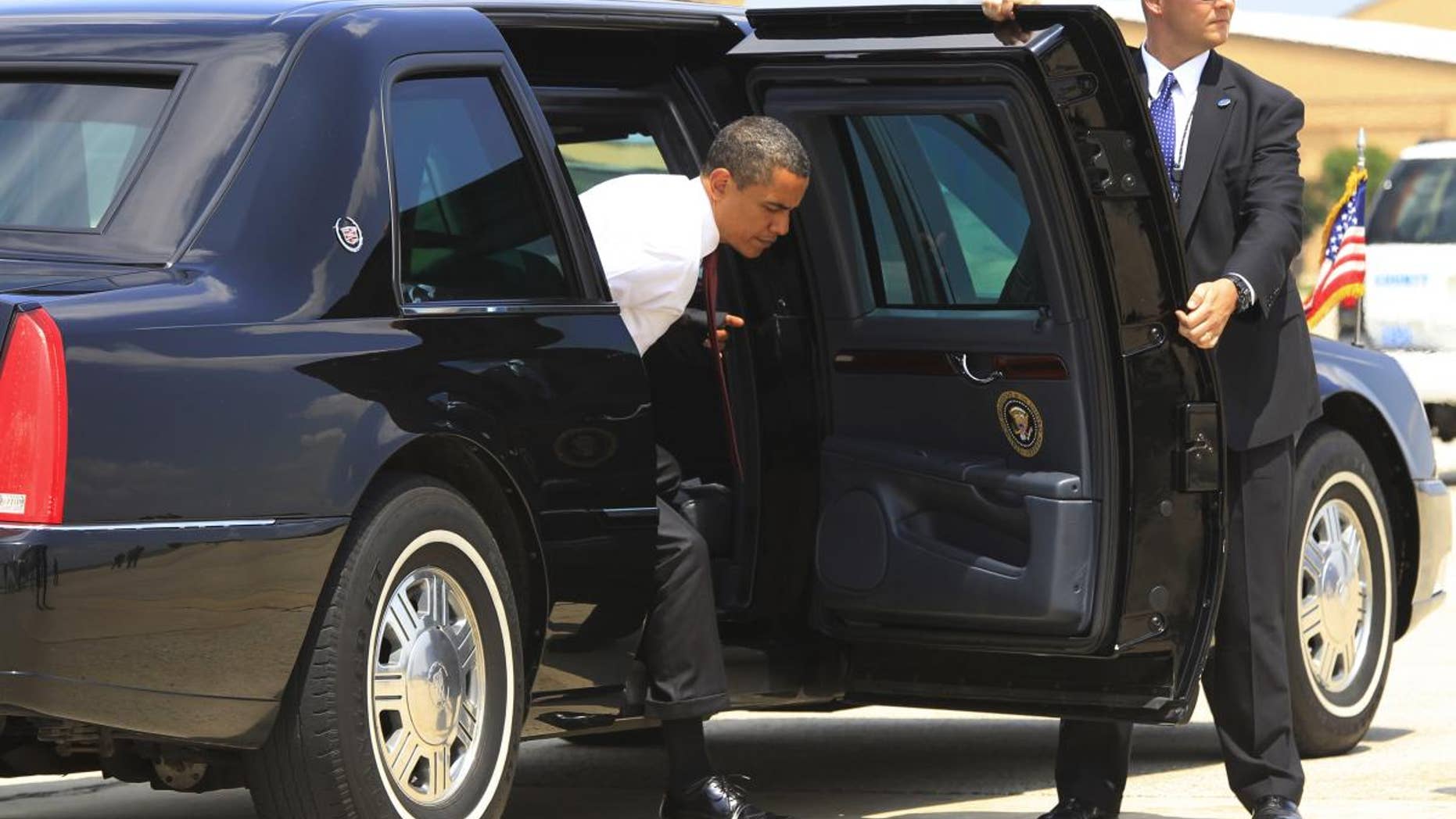 President Barack Obama steps out of the armored presidential limousine at Andrews Air Force Base. (AP File Photo/Charles Dharapak)