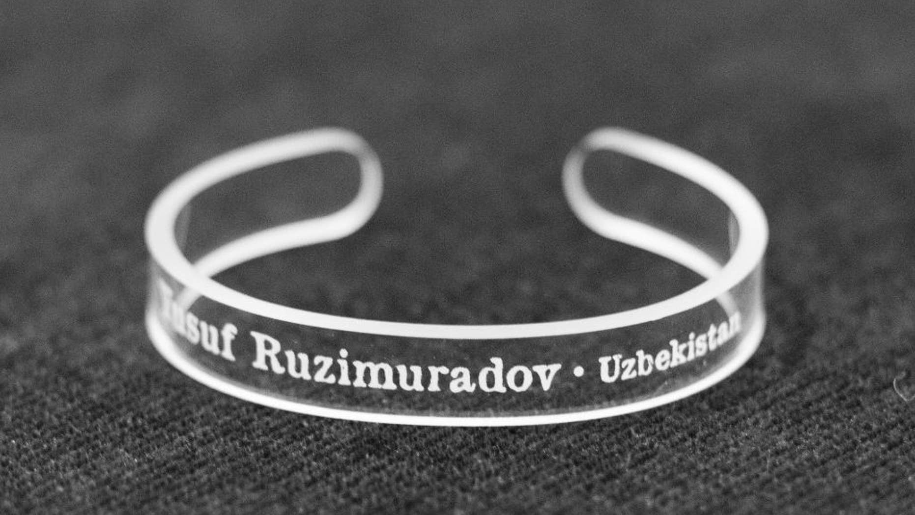 This handout photo provided by the Press Uncuffed Campaign shows a bracelet that University of Maryland journalism students are selling emblazoned with the names of journalists imprisoned around the world, to raise money for the cause, and awareness of their plight. The line includes 11 different bracelets, each with the name of a jailed journalist on it. The students are raising money to produce at least 10,000 bracelets. (AP Photo/Press Uncuffed Campaign)