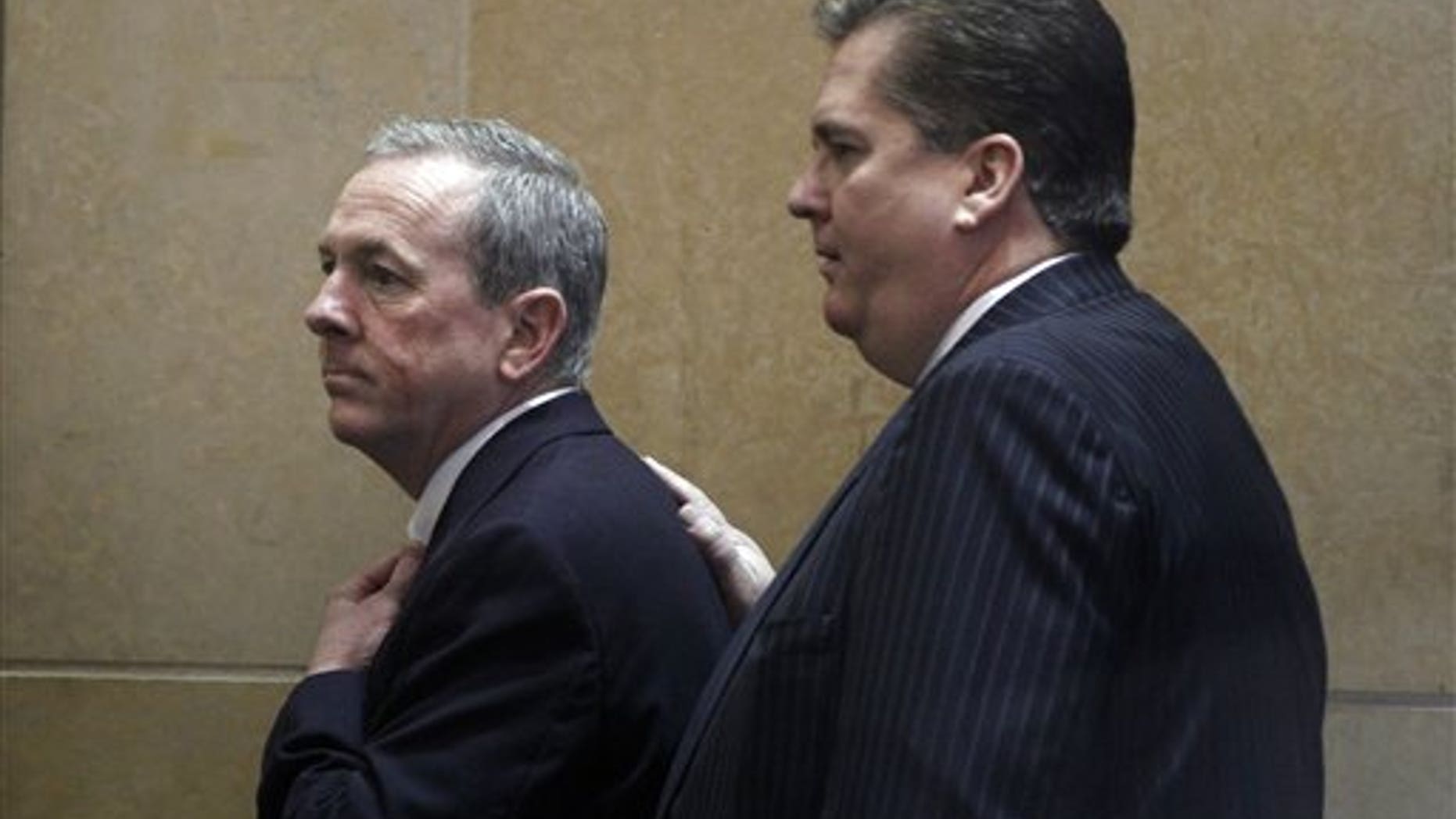 March 26: The Rev. James J. Brennan, left, arrives in the Criminal Justice Center in Philadelphia.