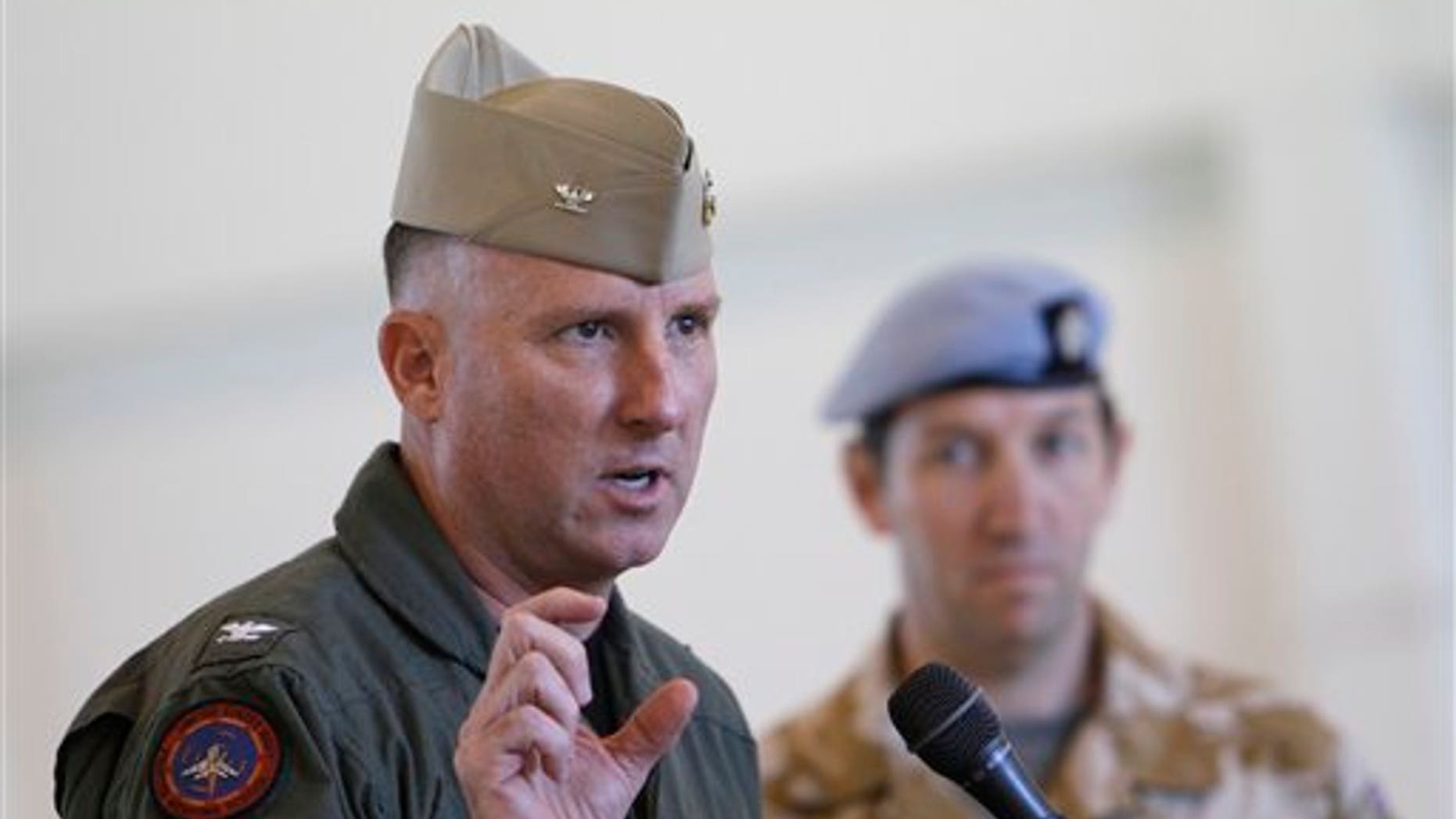 October 6: Captain Devon Jones, Commanding Officer of Naval Air Station El Centro, talks about exercise Crimson Eagle that will be conducted for the British Military as British officer Lt Col Peter Bullen looks on during a news conference in a hangar at the Naval Air Facility El Centro, California.