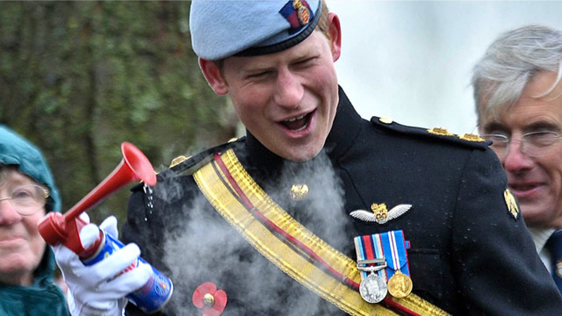 Nov. 9: Britain's Prince Harry laughs as an air horn given to him to start a military charity march malfunctions, during the opening of the Royal British Legion Field of Remembrance, at Wootton Bassett, England.