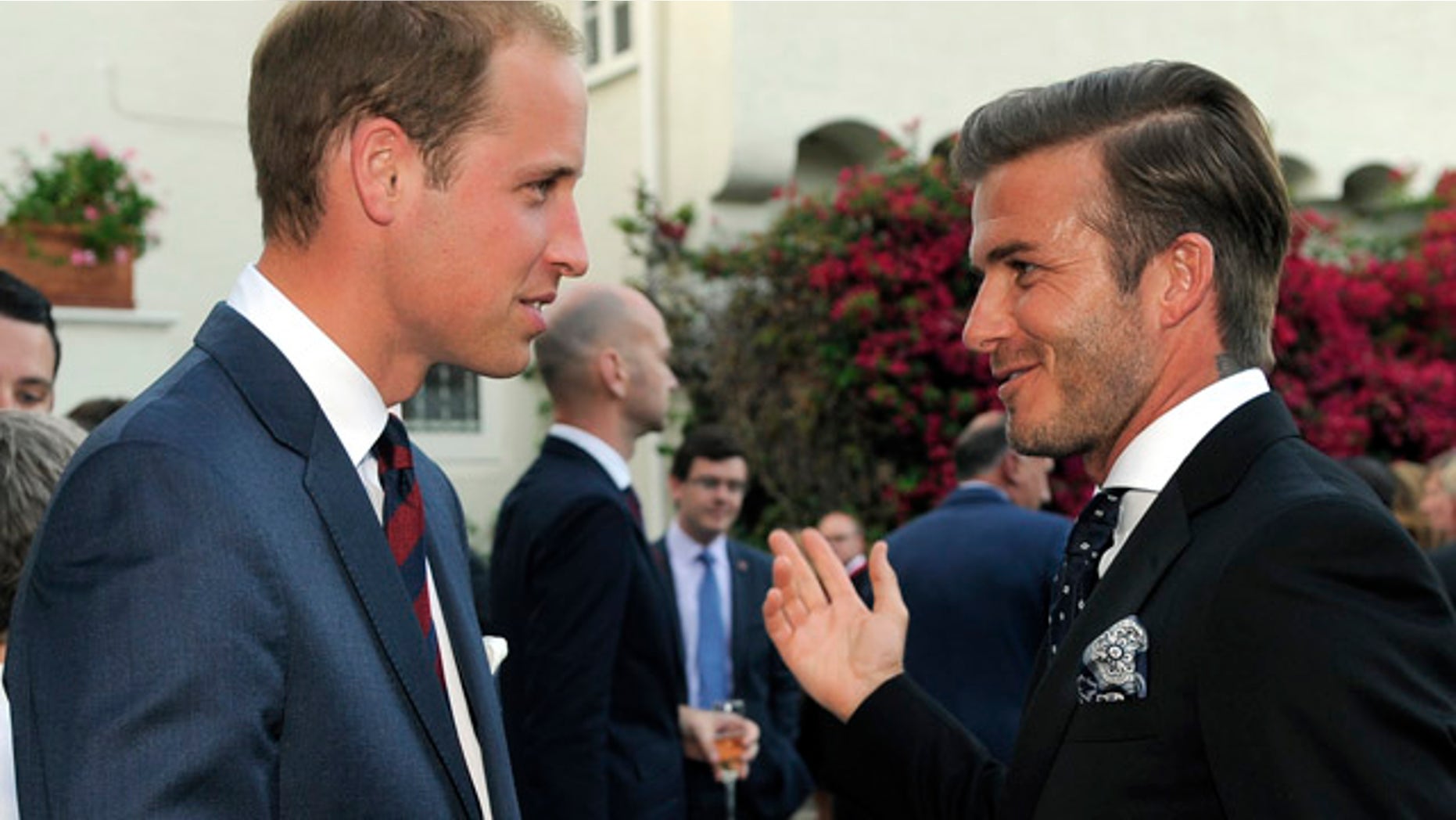 Prince William mingles with David Beckham during a private reception.