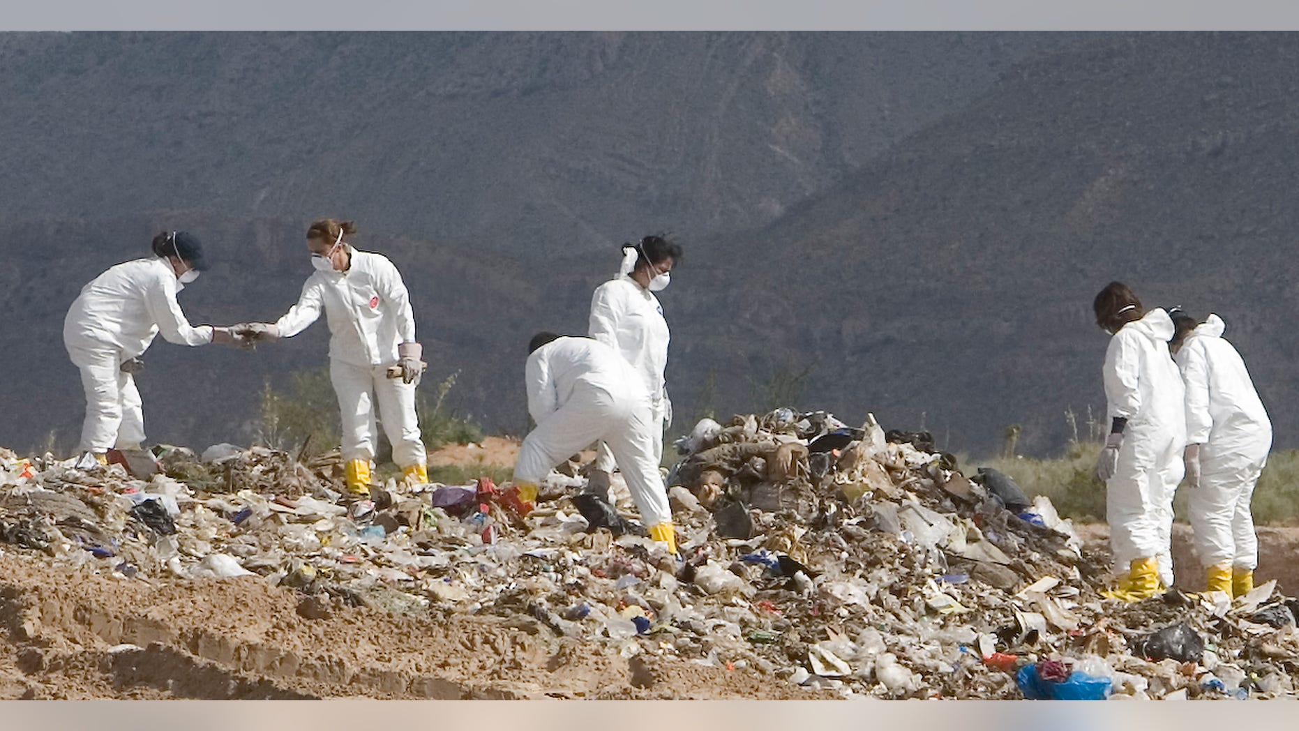 The crime scene unit with the El Paso County Sheriff's Office works to recover the body of Carlos Roberto Medina-Bailon at a landfill in New Mexico