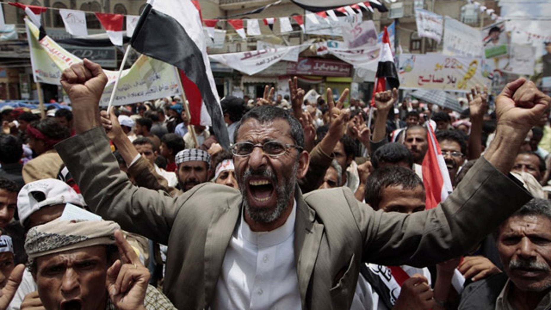 May 23: Anti-government protesters shout slogans during a rally to demand the ouster of Yemen's President Ali Abdullah Saleh. France on Monday accused Saleh of being irresponsible by refusing to sign a power transition agreement that would see him step down.