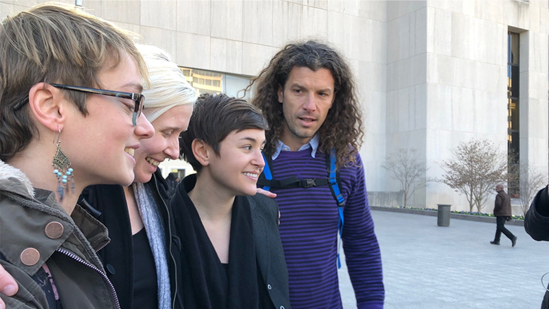 Four of the six acquitted Inauguration Day protesters, including Brittne Lawson (second to left) and Alexei Wood (far right), stood outside the courthouse following the verdict announcement.