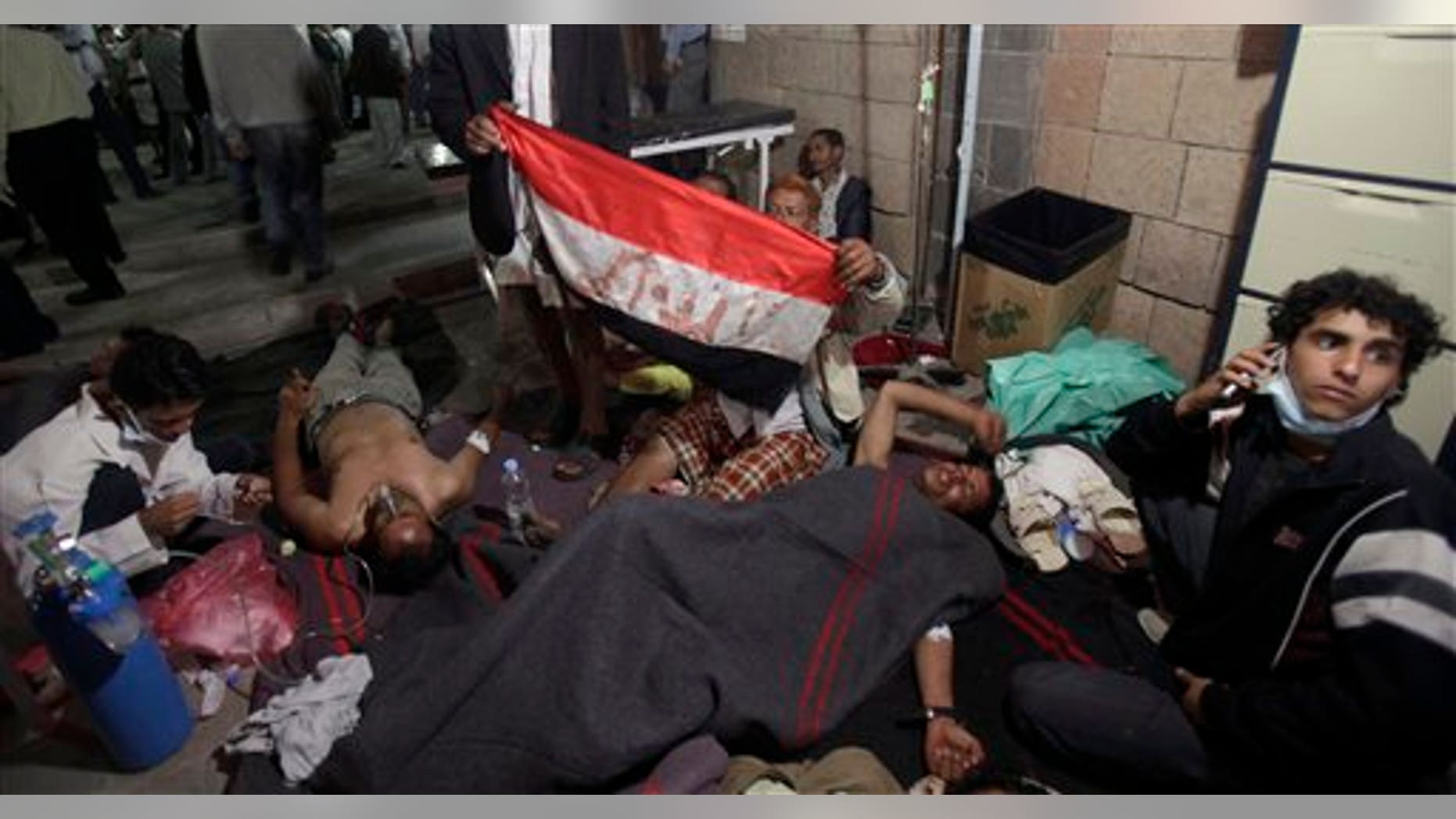 April 27: Wounded anti-government protestors lie on the ground of a field hospital following clashes with Yemeni security forces in Sanaa, Yemen.