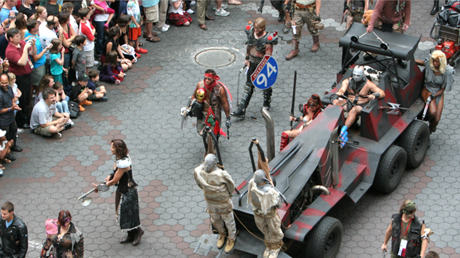 To the delight of onlookers, a parade based on the film "Mad Max" marches by during the 2009 Dragon Con.