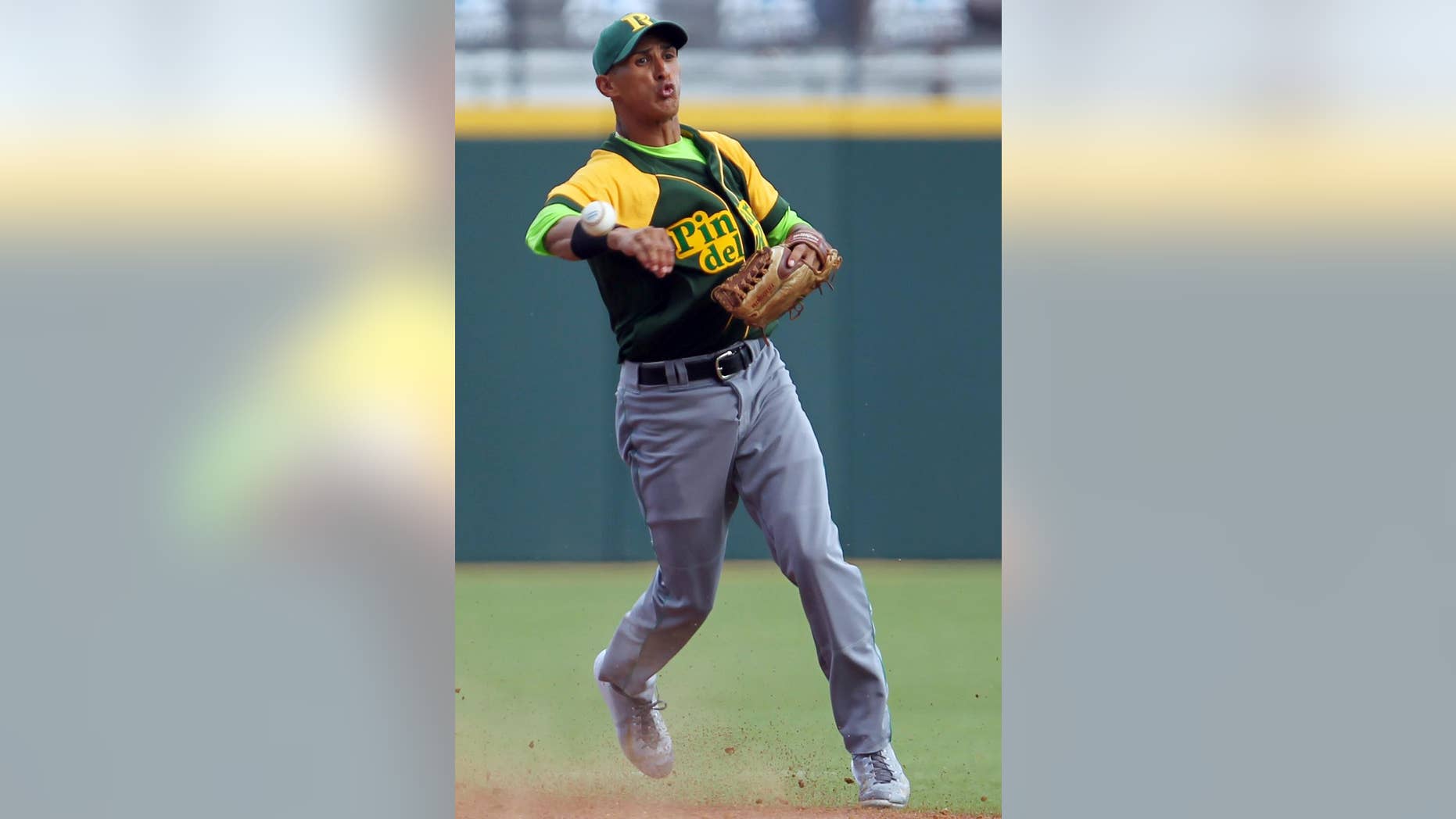 Cuba’s shortstop Dainer Moreira throws to first base during a Caribbean Series baseball game in San Juan, Puerto Rico, Tuesday, Feb. 3, 2015. Moreira is one of two Cuban baseball players who have apparently abandoned their team mid-tournament, Cuba's team said Wednesday. (AP Photo/Ricardo Arduengo)